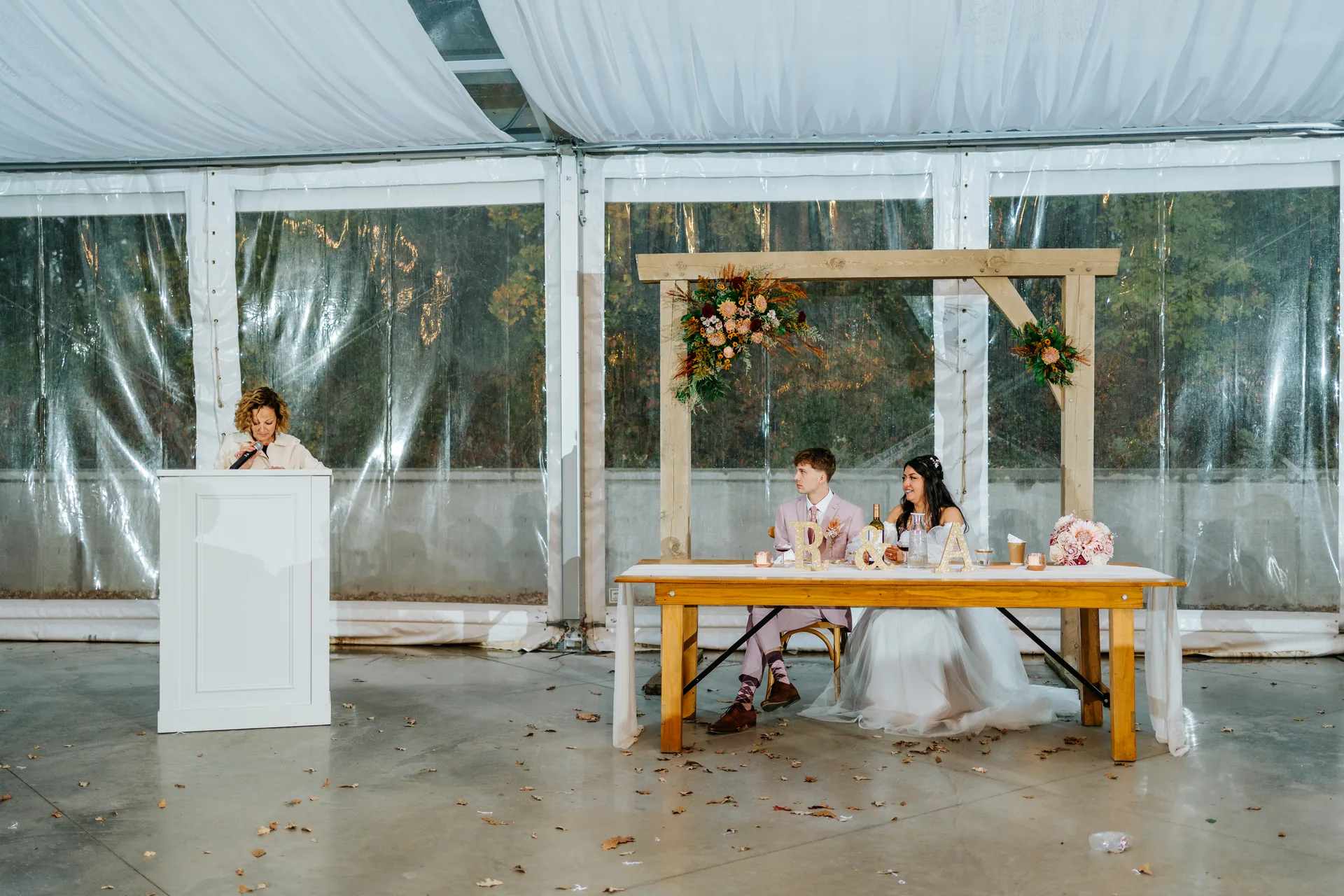 Wedding party dancing in blush dresses inside the glass tent at Oakland Estates Manitoba — Ngo Photography
