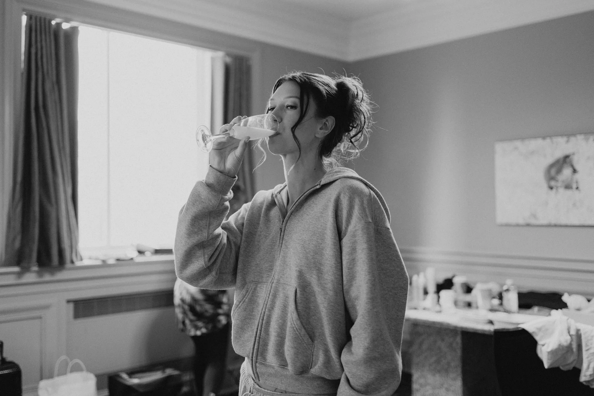Bride with champagne getting ready at the Fort Garry Hotel, Winnipeg — Stephanie and Brock wedding photography by Chris Ngo