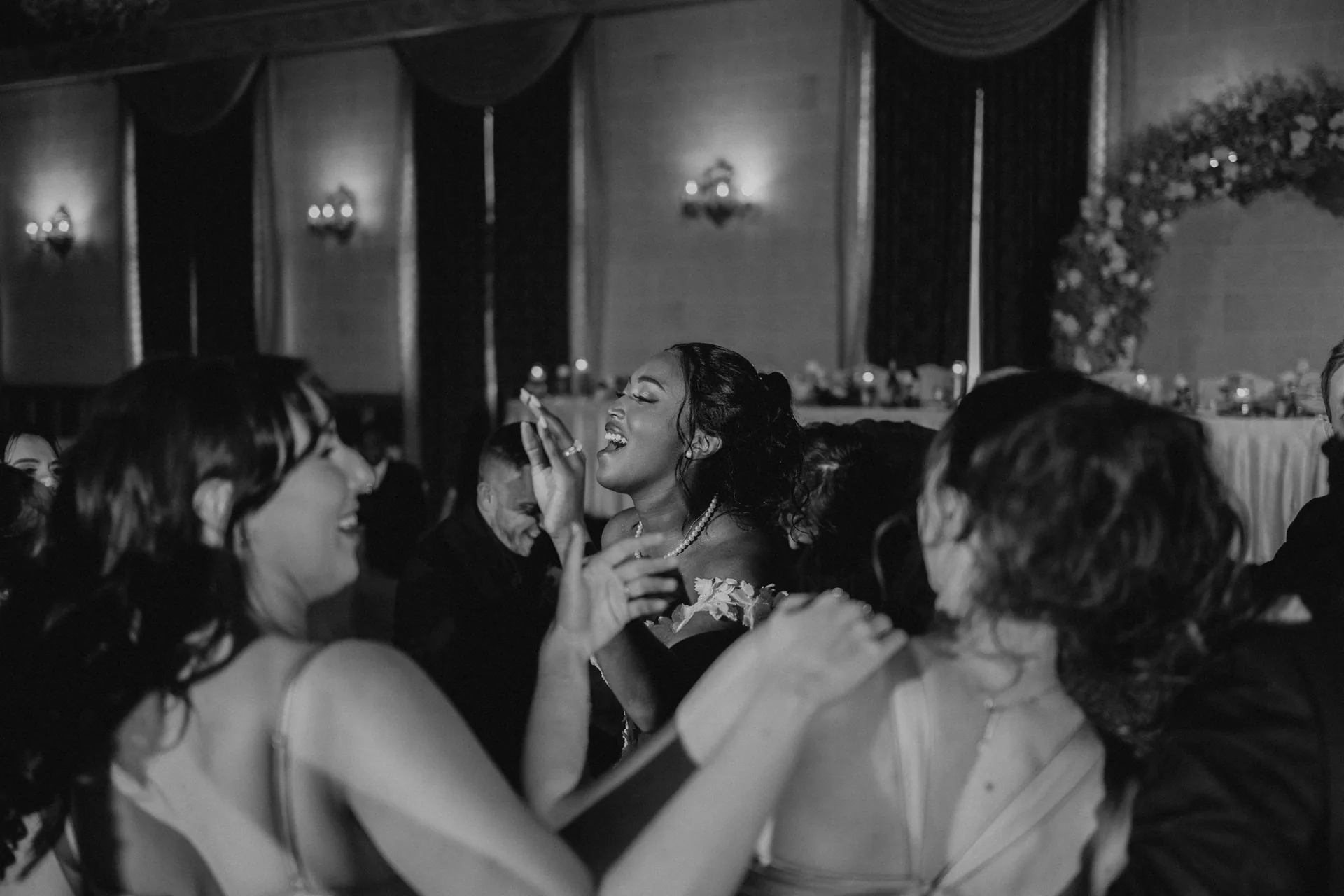 Bride dancing with bridesmaids on the Provencher Ballroom dance floor at the Fort Garry Hotel, Winnipeg