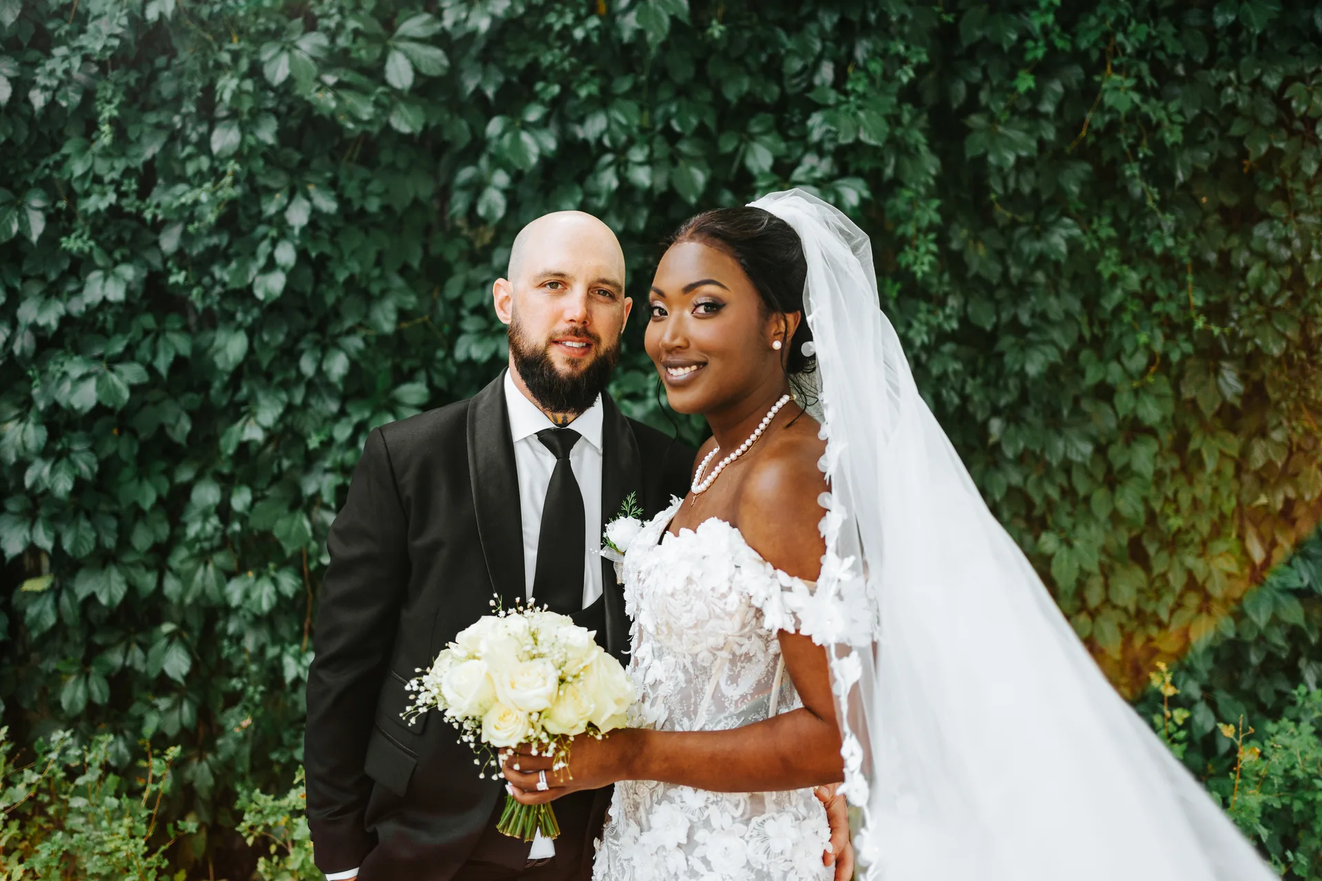 Couple portrait against the ivy-covered wall at The Forks, Winnipeg — Fort Garry Hotel wedding