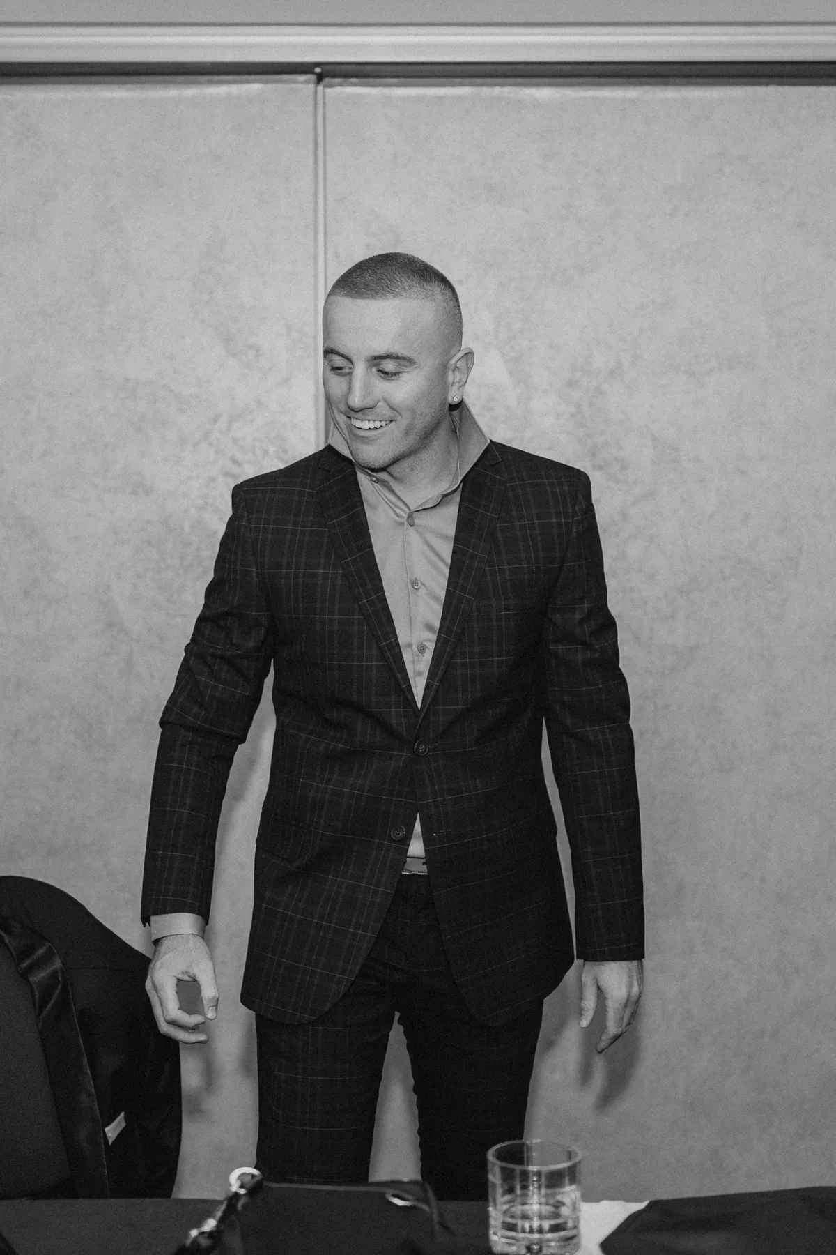 Groom in his black three-piece suit in the Fort Garry Hotel room, Winnipeg