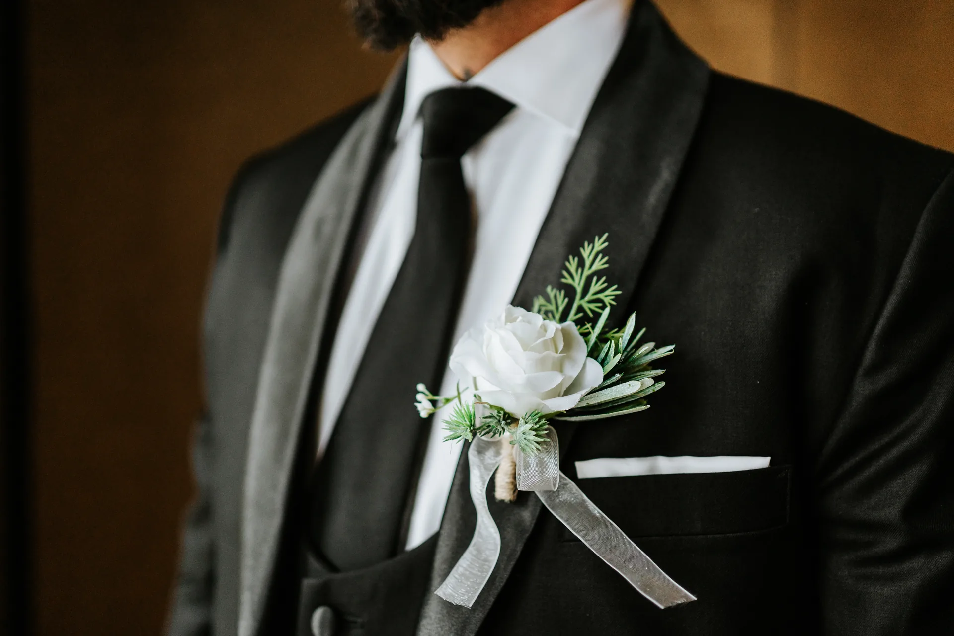 Groomsmen getting ready in black suits at the Fort Garry Hotel, Winnipeg