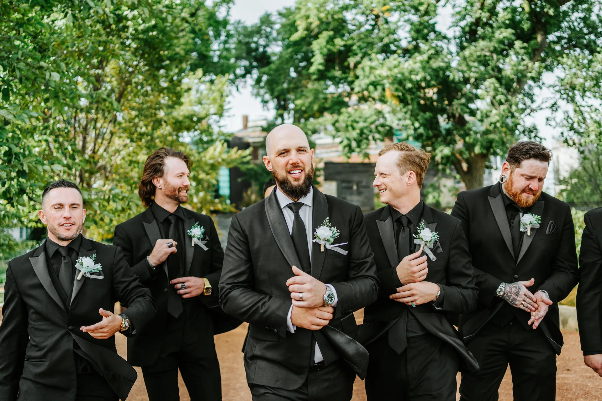 Groomsmen laughing together during outdoor portraits at The Forks, Winnipeg