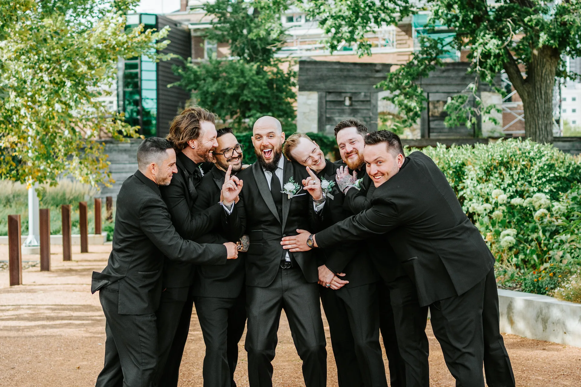 Groomsmen in black suits outdoor portrait at The Forks, Winnipeg — Fort Garry Hotel wedding