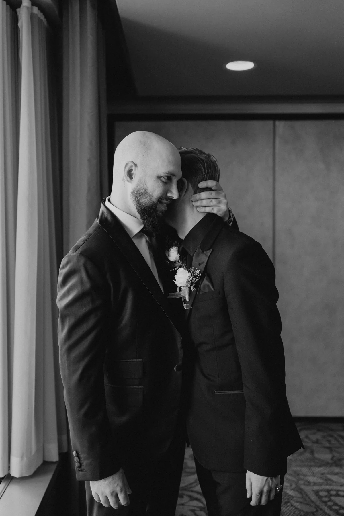 Groomsmen together in black suits at the Fort Garry Hotel, Winnipeg