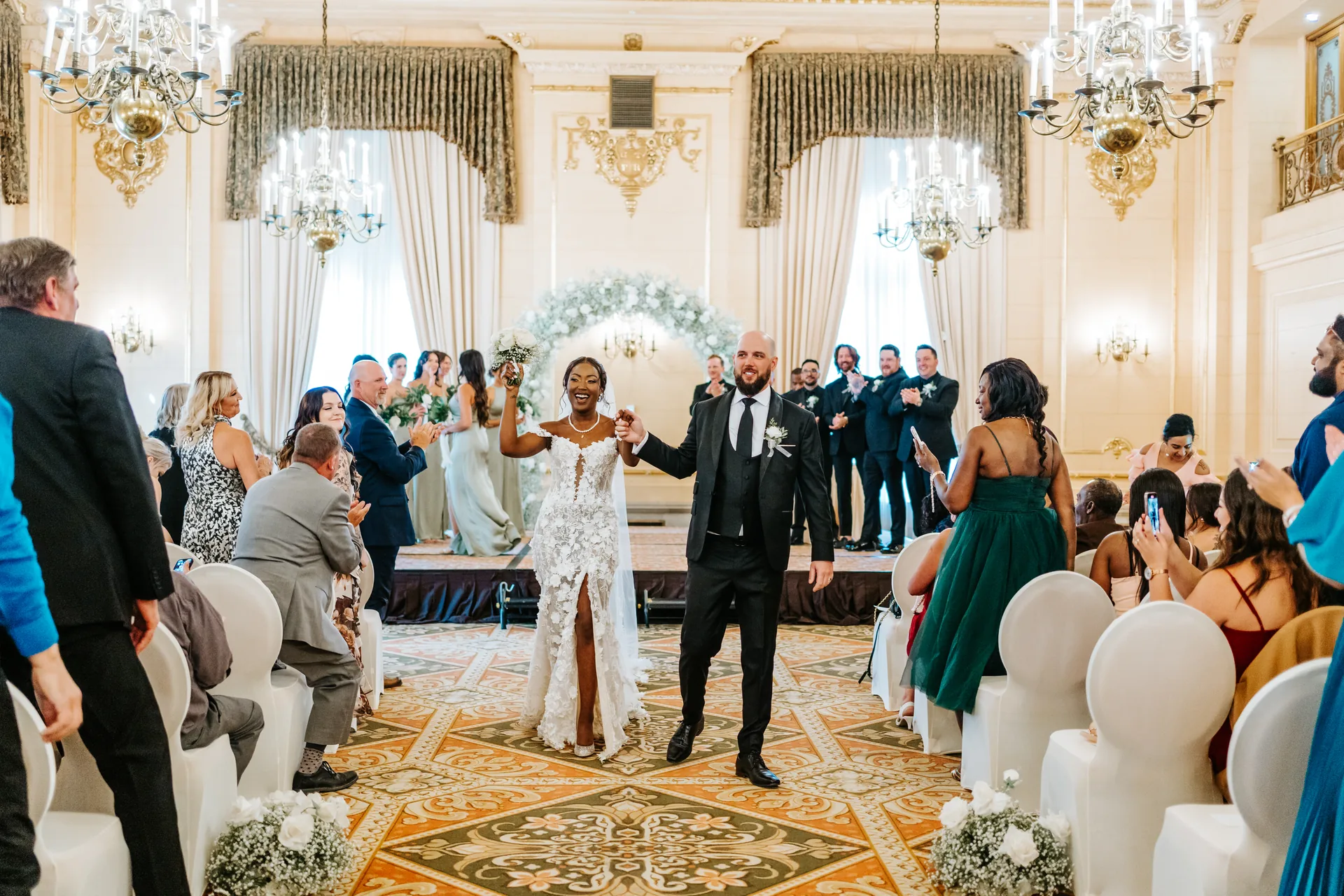 Newlyweds walking the recessional as husband and wife through the Provencher Ballroom, Fort Garry Hotel, Winnipeg