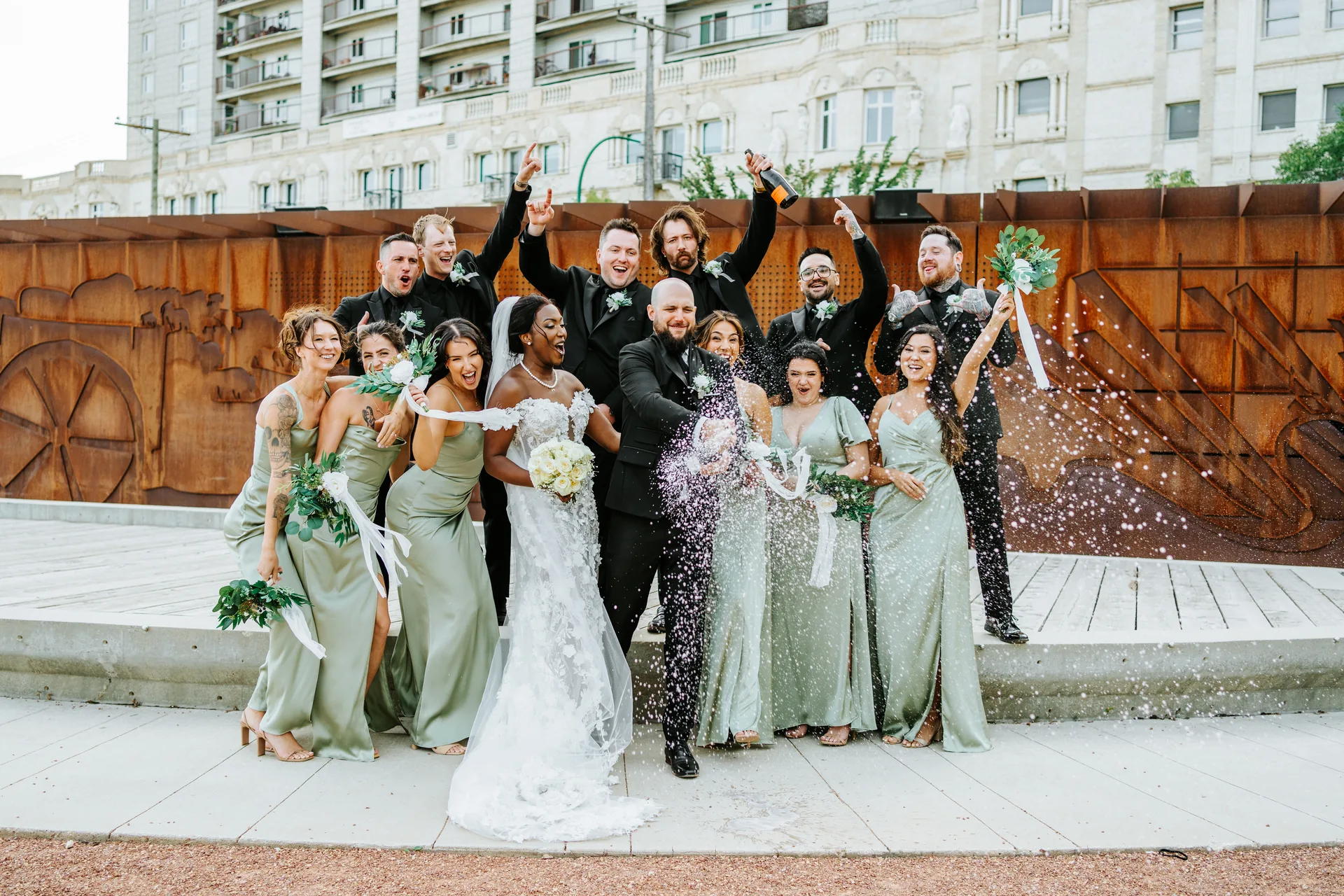 Wedding party champagne spray celebration at The Forks, Winnipeg — Stephanie and Brock Fort Garry Hotel wedding