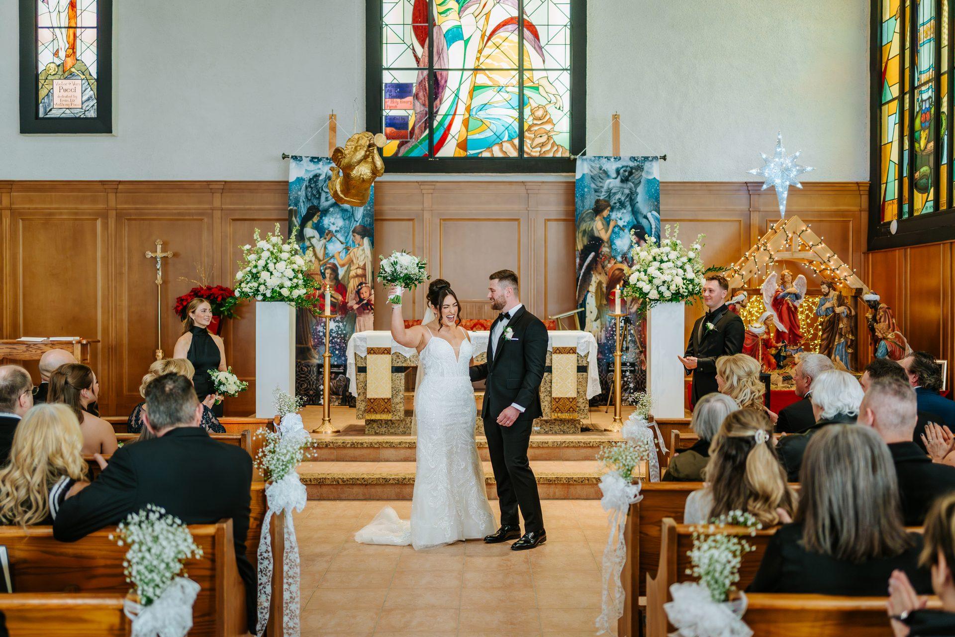 Couple celebrating their first kiss as a married couple at the altar of Holy Rosary Church, Winnipeg