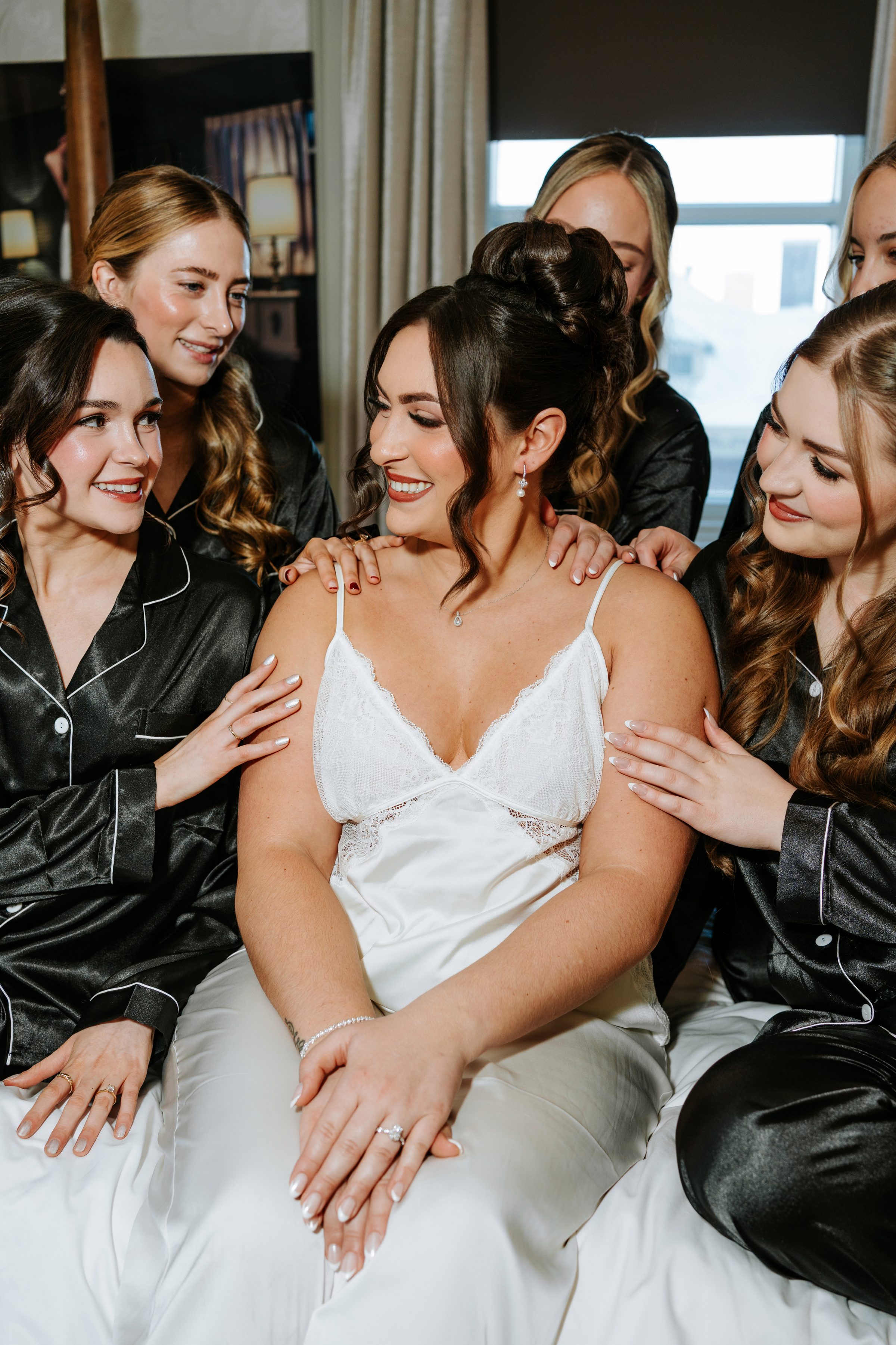 Stef surrounded by her bridesmaids in matching black pyjamas on her wedding morning — Ngo Photography Winnipeg