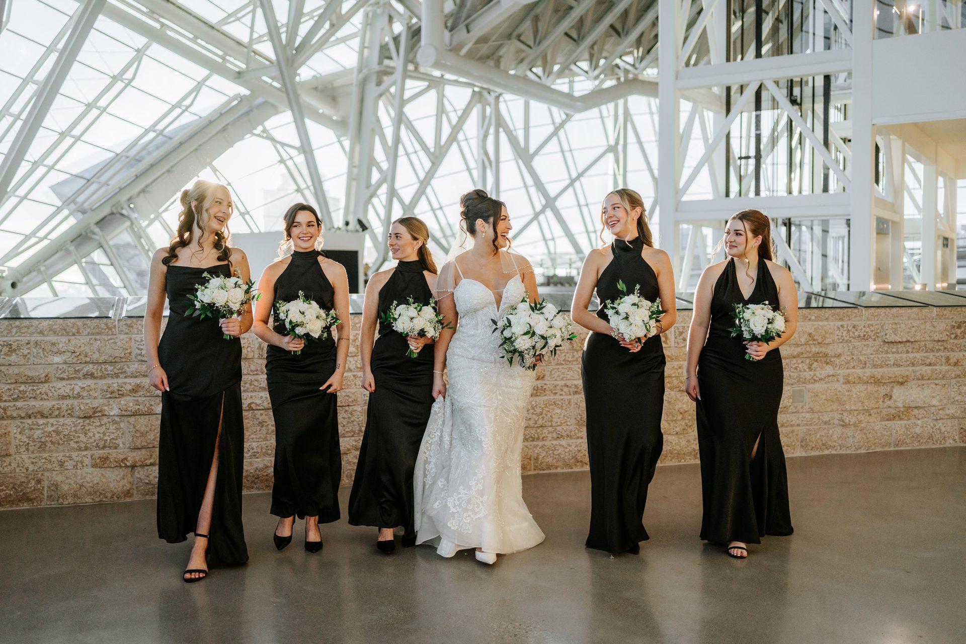Bridesmaids laughing together at the Canadian Museum for Human Rights, Winnipeg