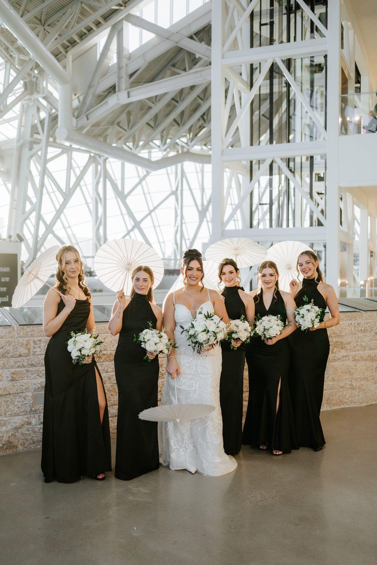 Bridesmaids with parasols at the Canadian Museum for Human Rights wedding portraits, Winnipeg
