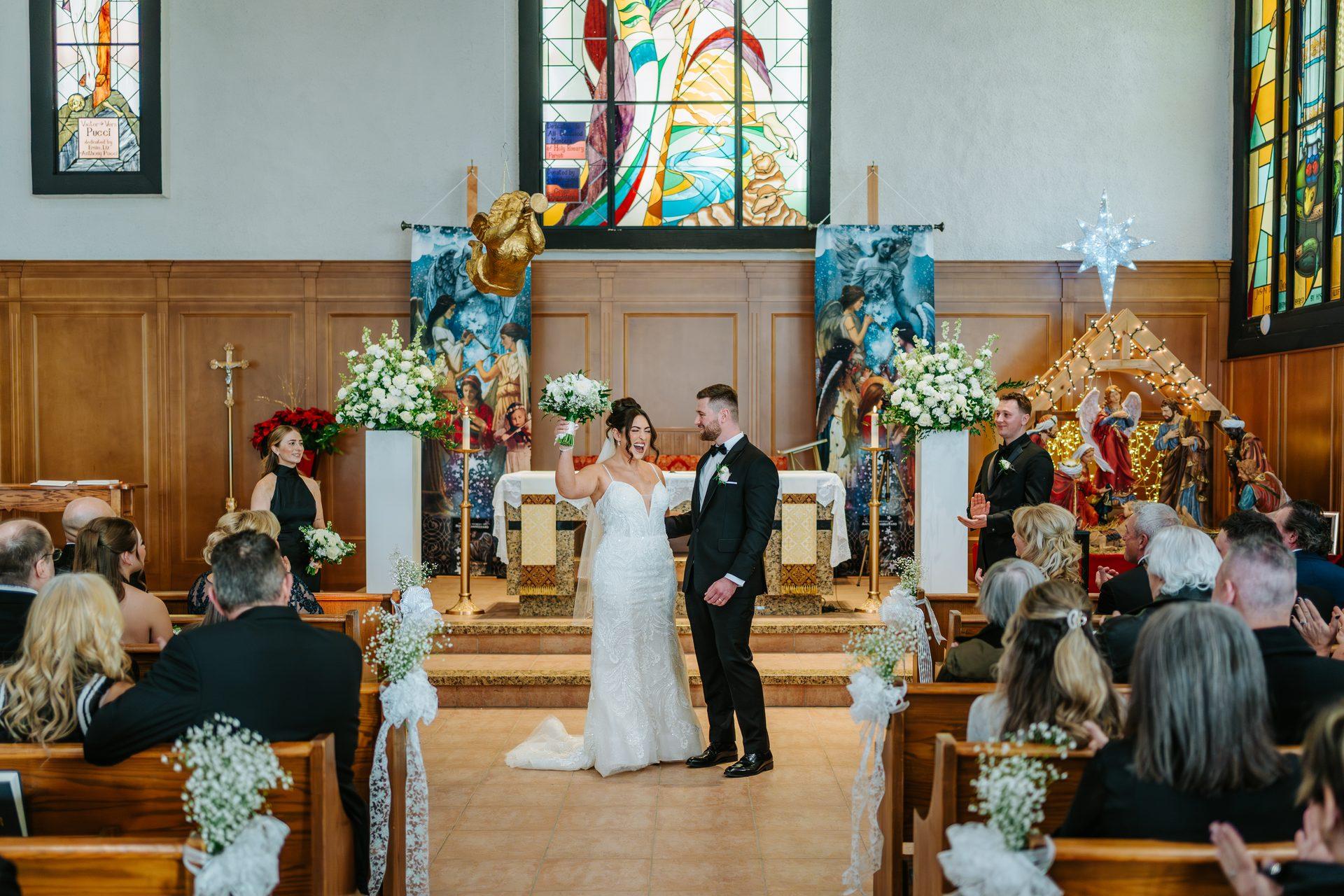 Couple at the altar with the full congregation at Holy Rosary Church, Winnipeg