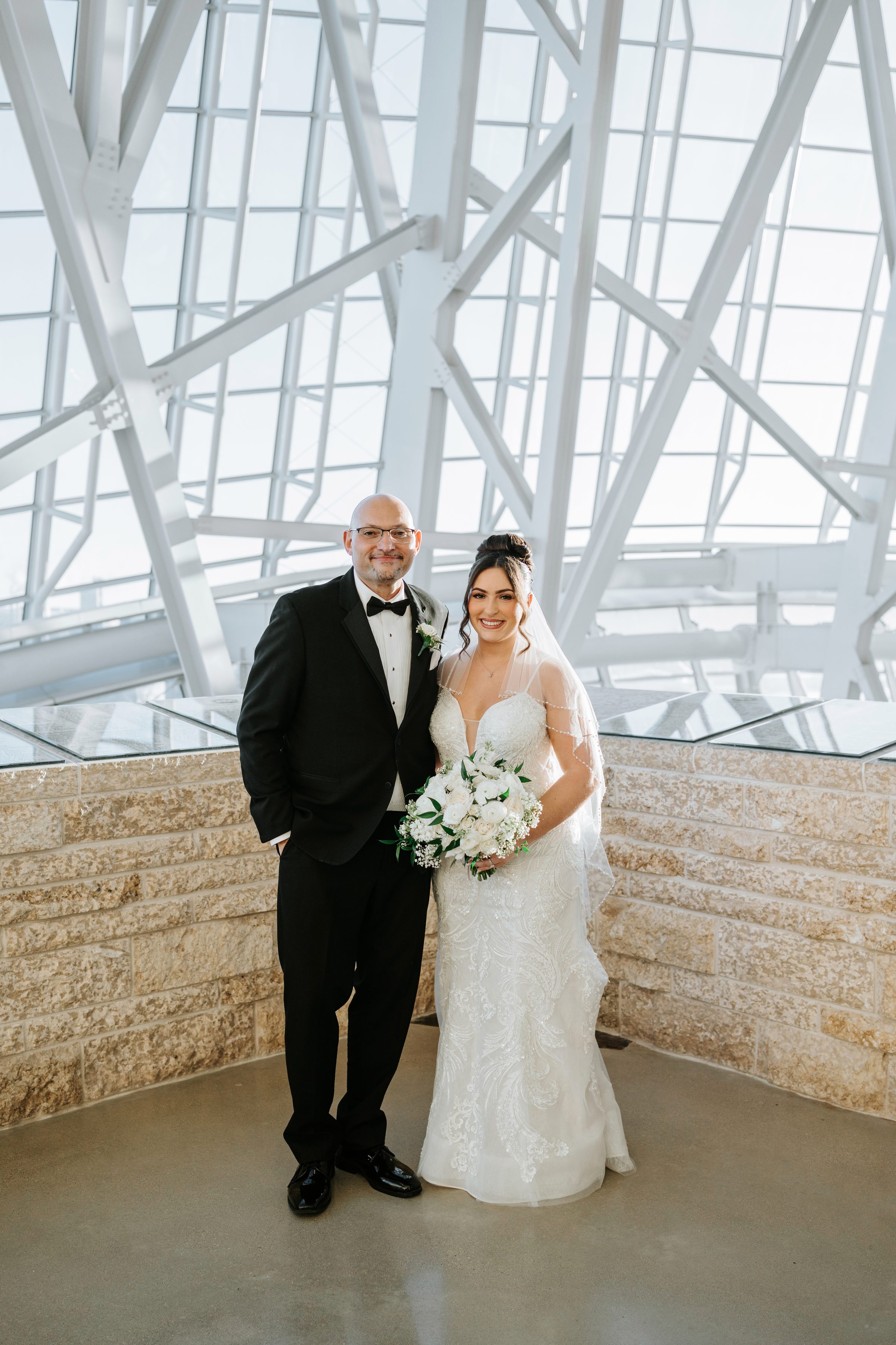 Stef and Brett couple portrait inside the Canadian Museum for Human Rights with geometric glass architecture — Chris Ngo Winnipeg wedding photographer