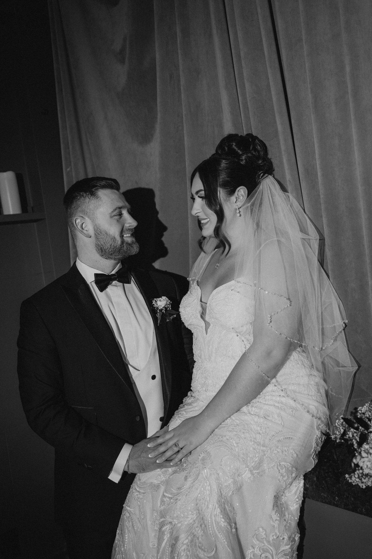 Couple portrait against the velvet curtains at The Fort Garry Hotel wedding reception Winnipeg — editorial wedding photography by Chris Ngo