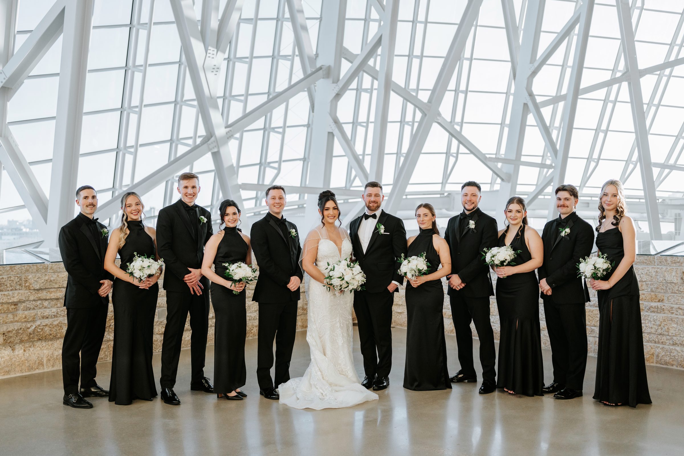 Full wedding party lineup inside the Canadian Museum for Human Rights Winnipeg — wedding photography by Ngo Photography