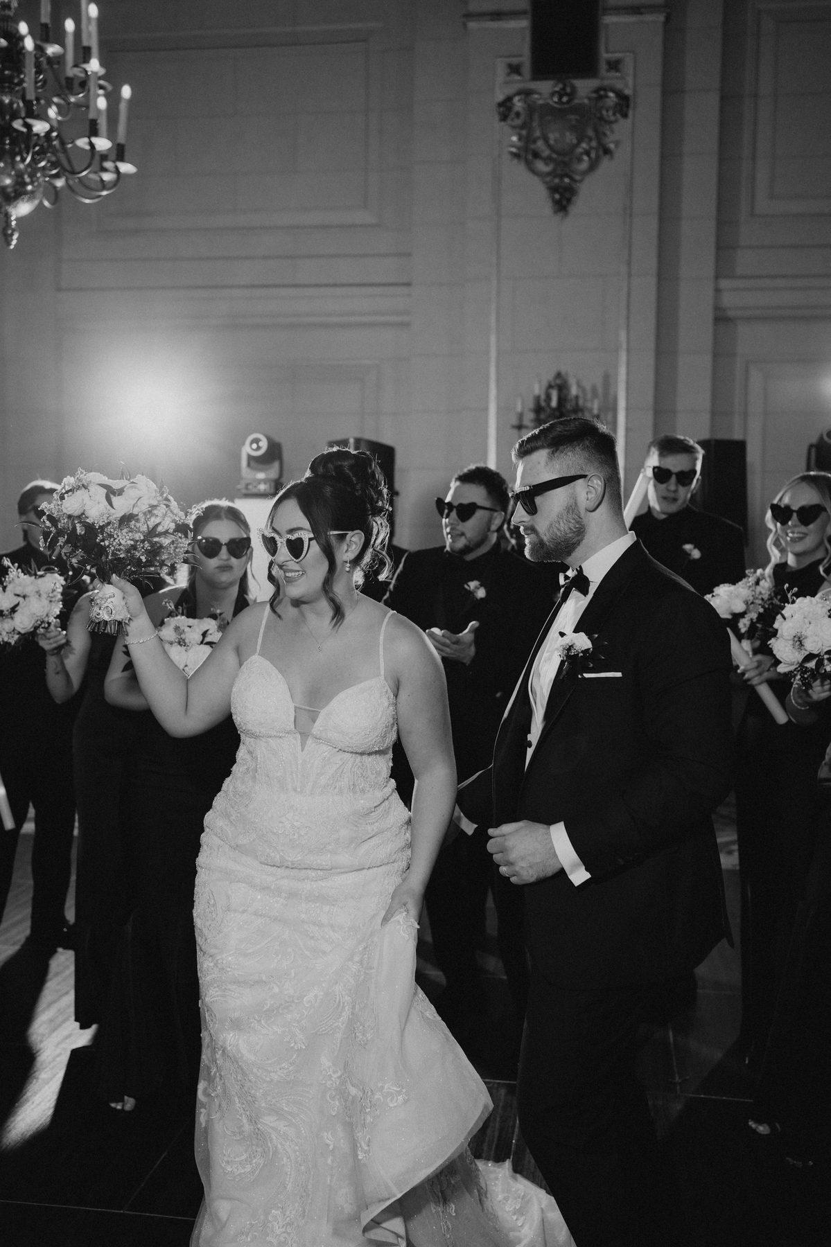 Couple making their grand entrance in matching sunglasses into the Provencher Ballroom at The Fort Garry Hotel Winnipeg — Ngo Photography