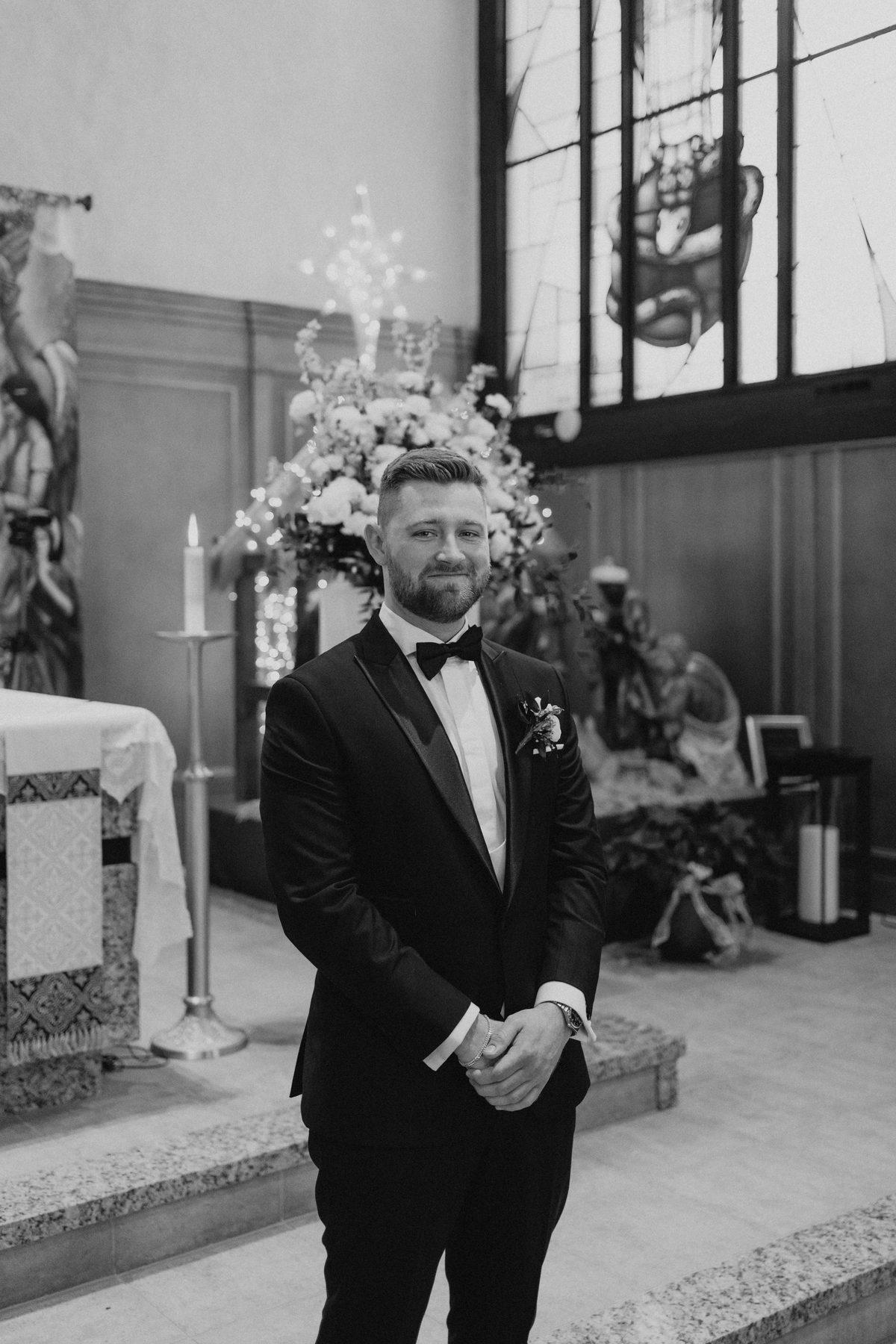 Groom portrait at the altar of Holy Rosary Church, Winnipeg