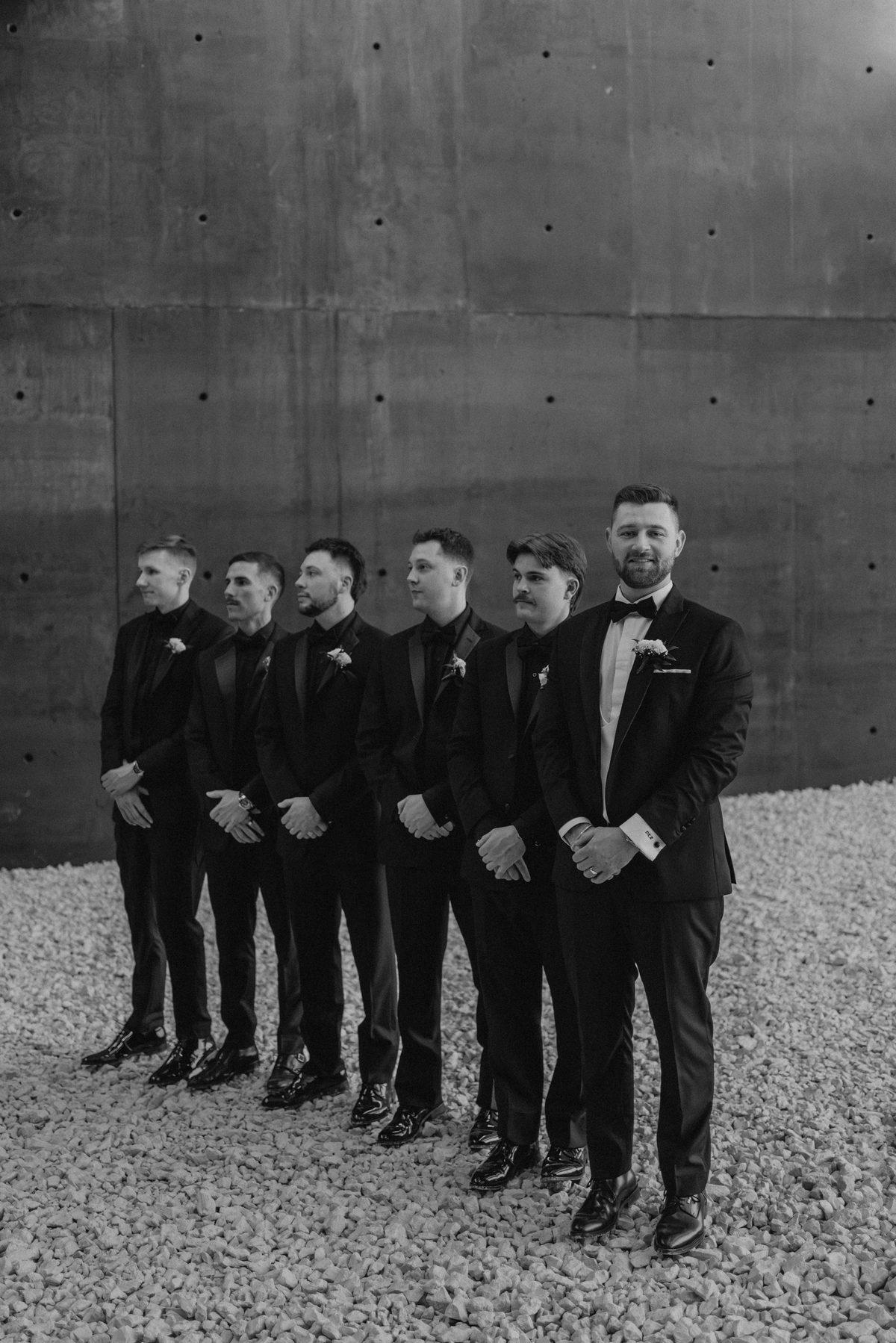 Groomsmen in black tuxedos at the Canadian Museum for Human Rights, Winnipeg