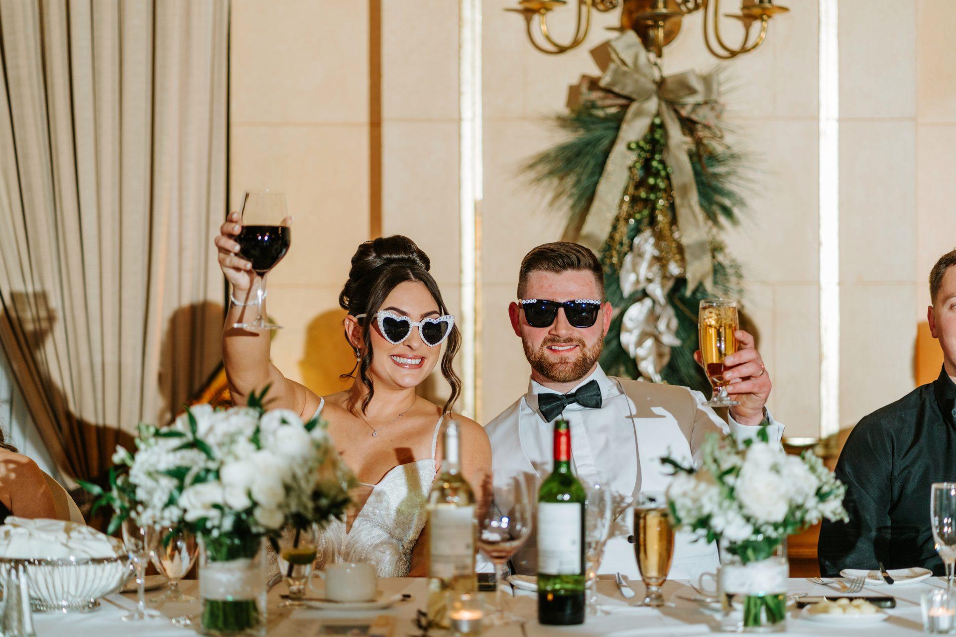 Heart-shaped sunglasses and champagne toast at the New Year's Eve wedding reception, Fort Garry Hotel, Winnipeg