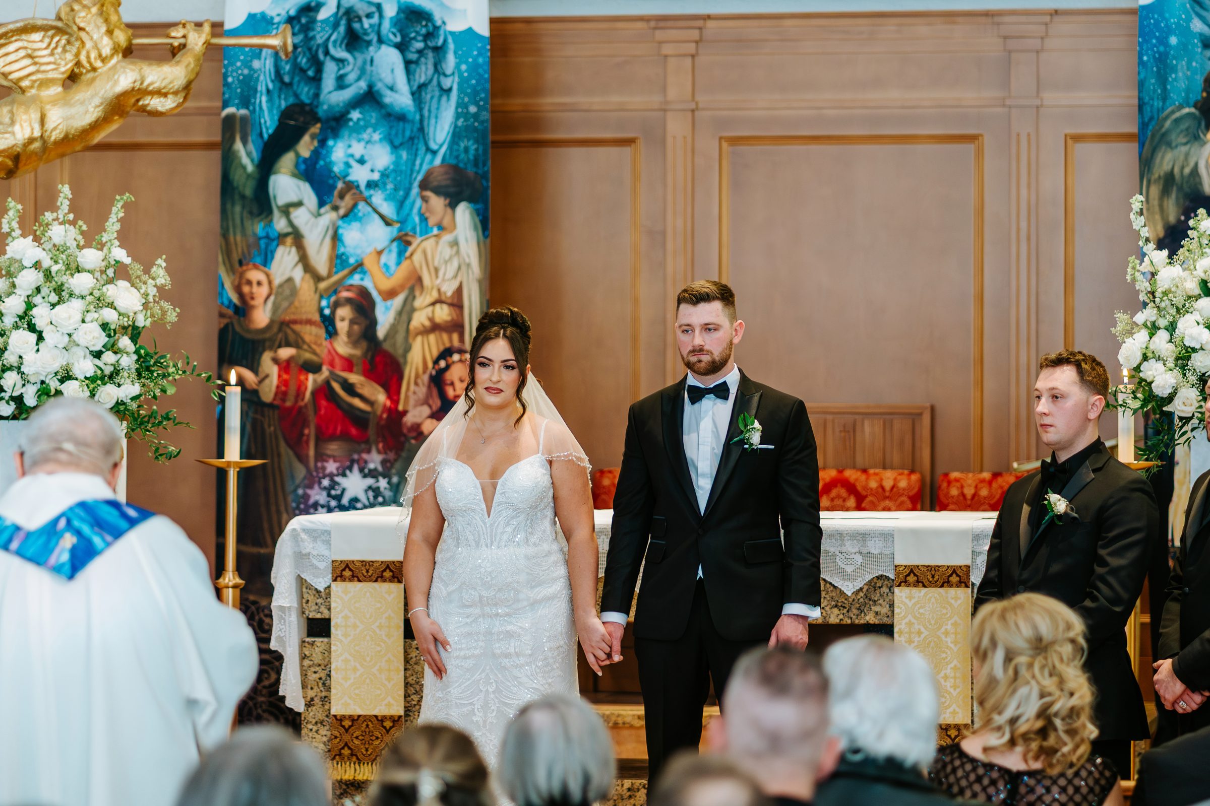Stef and Brett at the altar during their church ceremony — Winnipeg wedding photographer Chris Ngo