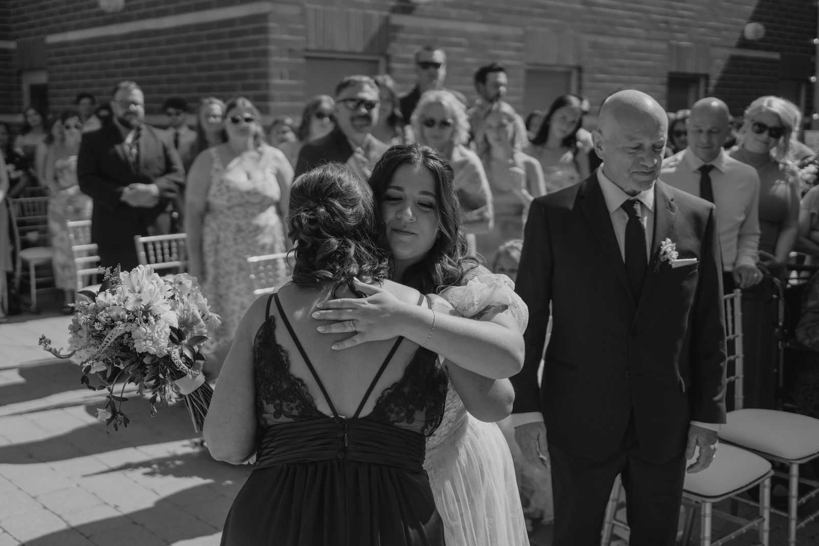 Guests arriving at the Caboto Centre outdoor Piazza ceremony — Stephanie and Drew wedding, photography by Chris Ngo Winnipeg