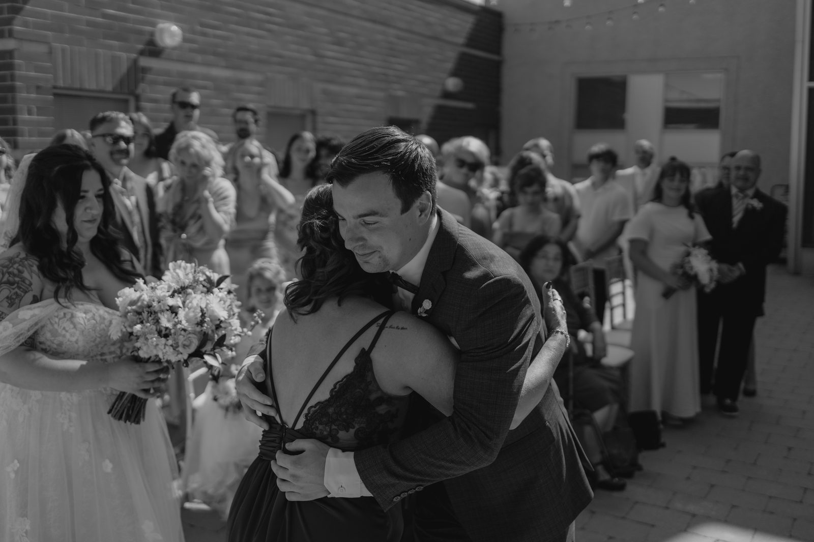 The Caboto Centre Piazza ceremony space — wooden arbor, white draping, Edison lights, photography by Ngo Photography