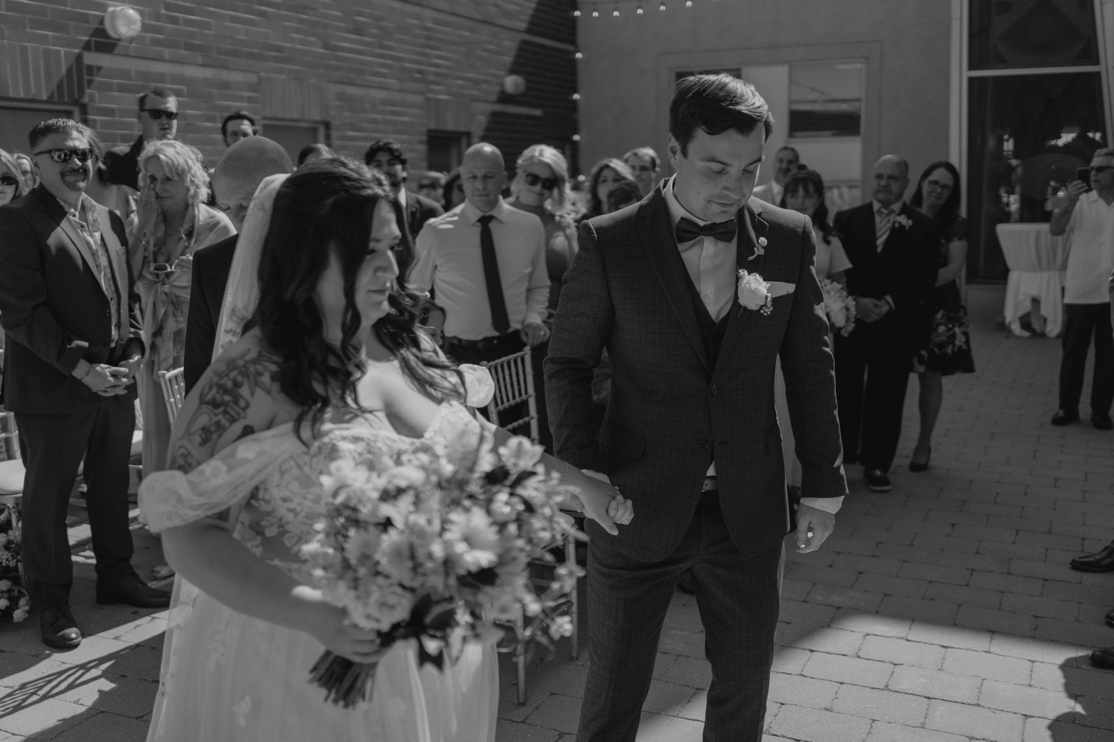 Wide ceremony shot at the Caboto Centre outdoor Piazza — Stephanie and Drew's Winnipeg wedding, photography by Chris Ngo