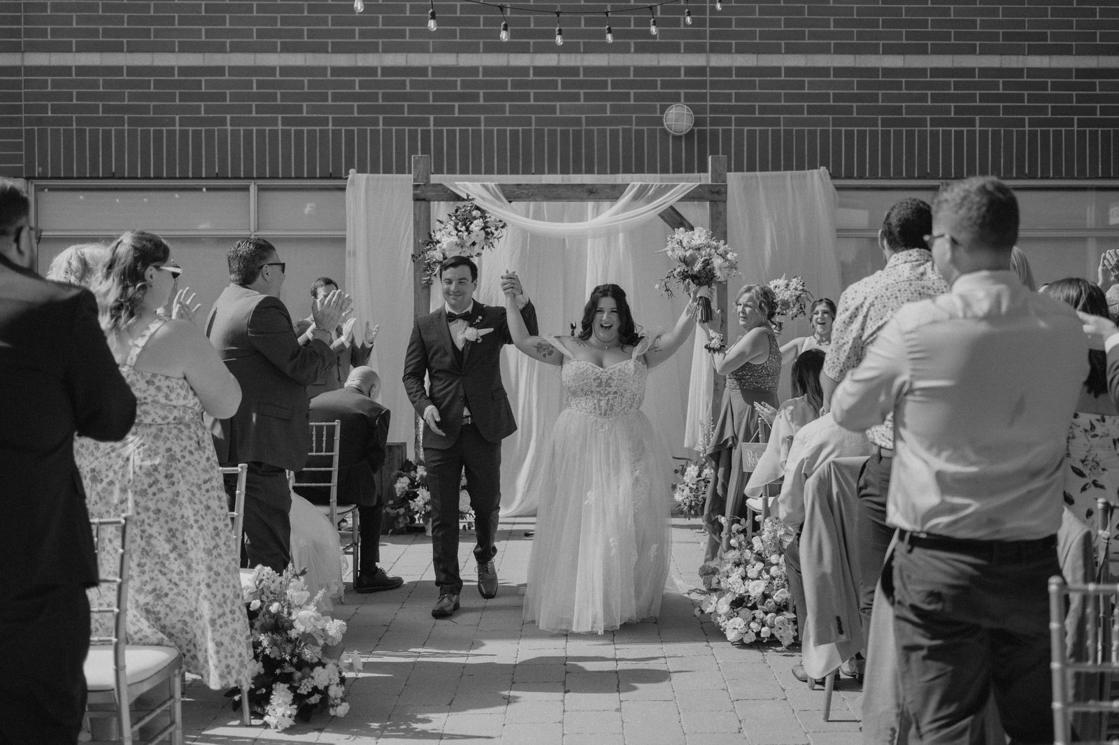 Ring exchange during Caboto Centre outdoor ceremony — Stephanie and Drew's Winnipeg wedding by Chris Ngo