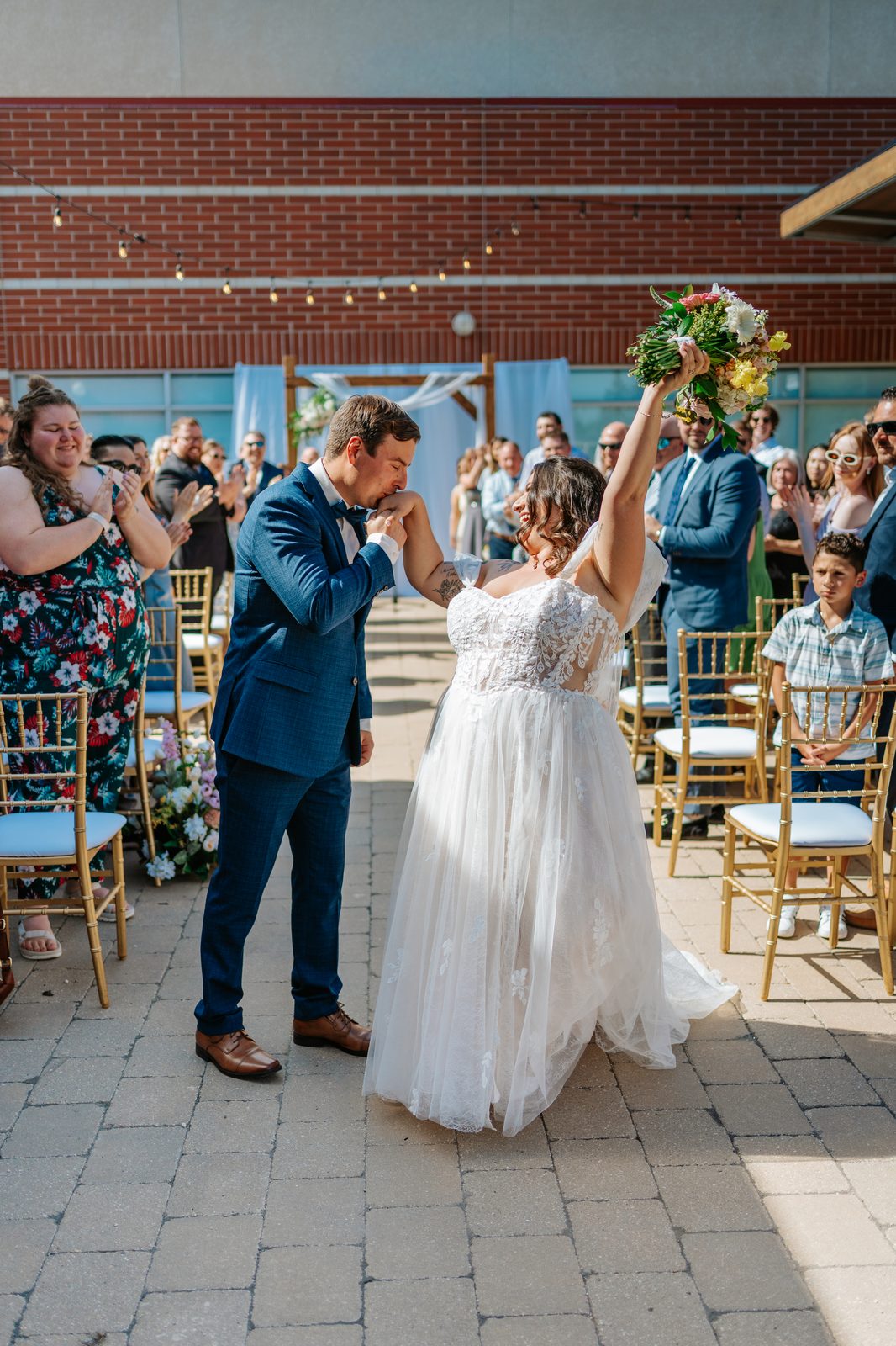 The kiss at the Caboto Centre outdoor ceremony — Stephanie and Drew married, photography by Ngo Photography Winnipeg