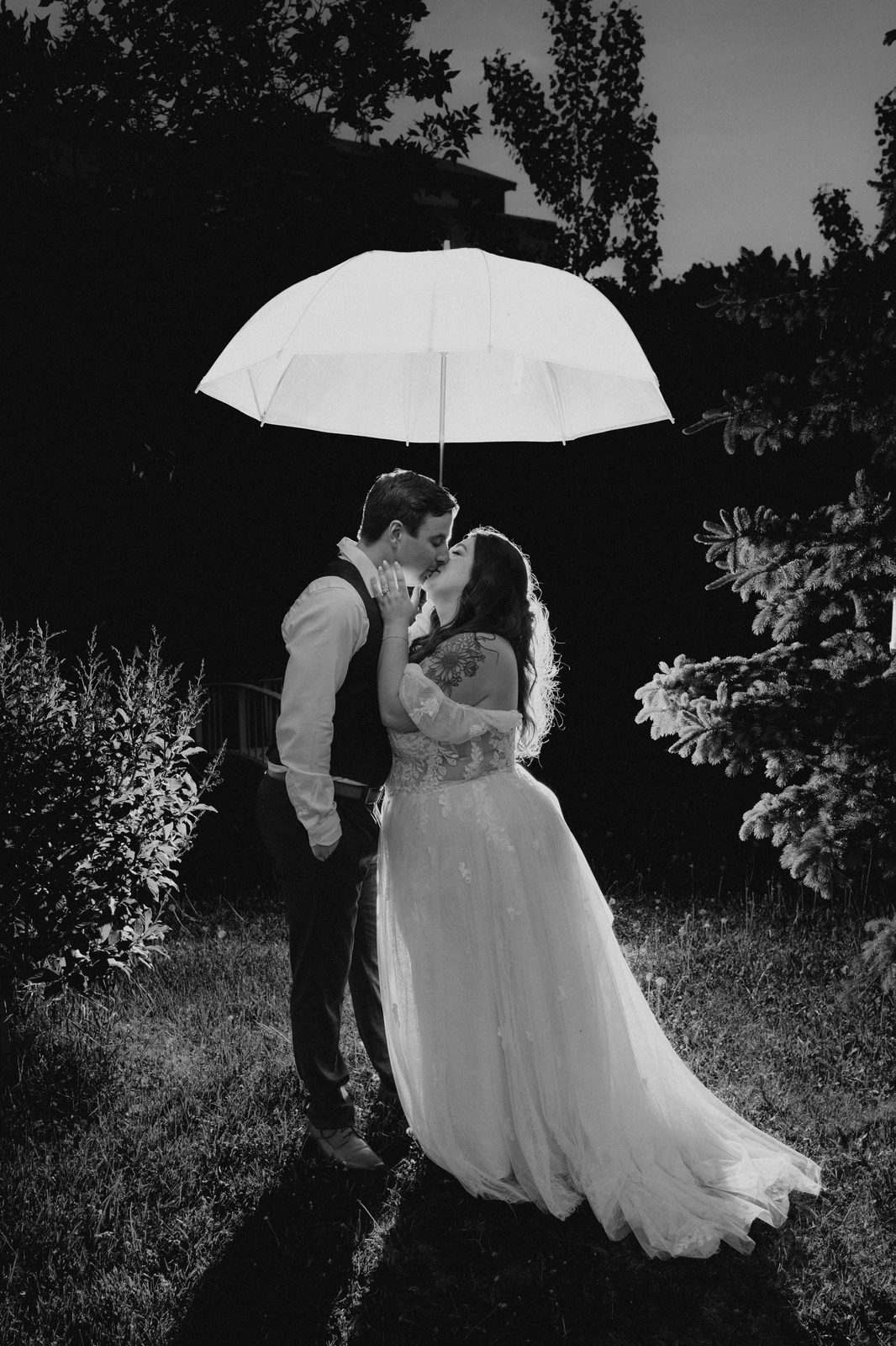 Evening umbrella portrait in golden Manitoba summer light — Stephanie and Drew's Caboto Centre wedding by Ngo Photography
