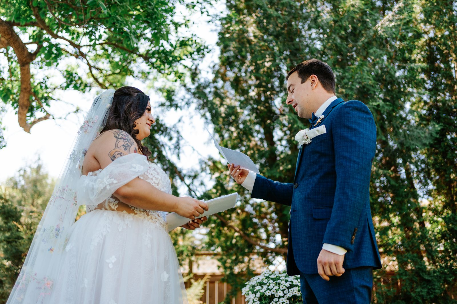 Stephanie and Drew reading vows in the garden — Caboto Centre Winnipeg wedding, photography by Ngo Photography
