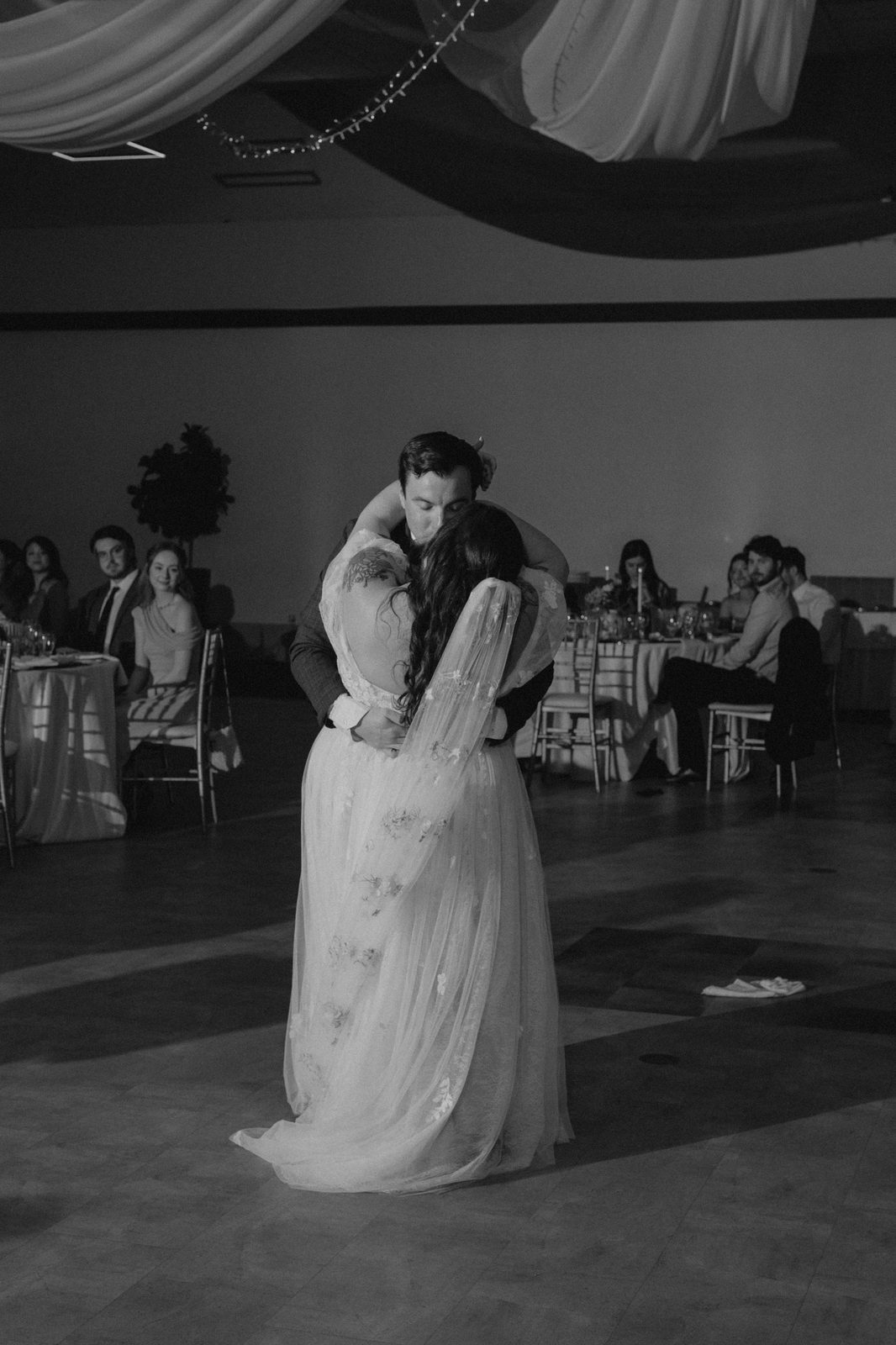 Stephanie and Drew's first dance in the Caboto Centre Mauro Hall — black and white, photography by Chris Ngo, Ngo Photography Winnipeg