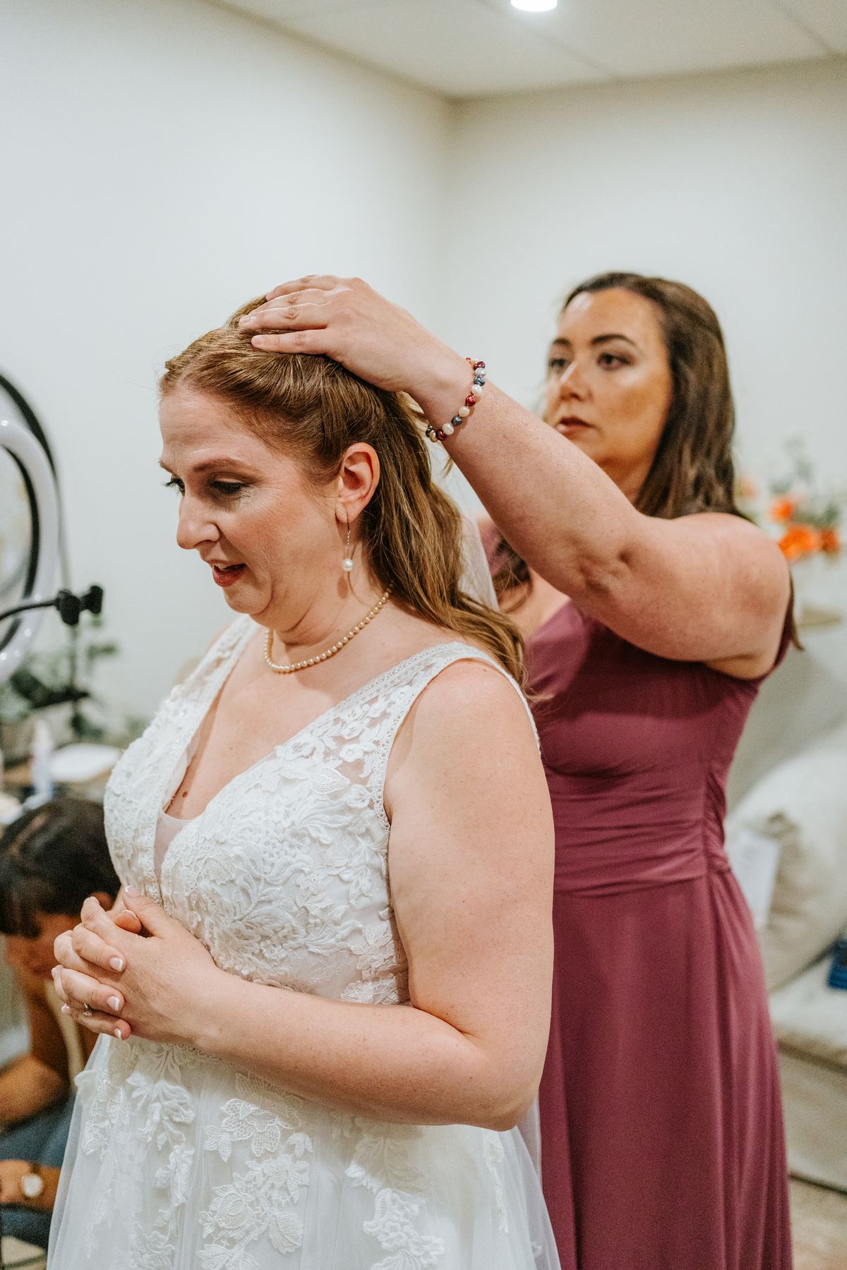 Bride Tara getting dressed with bridesmaids helping at Pineridge Hollow wedding, Pine Ridge, Manitoba