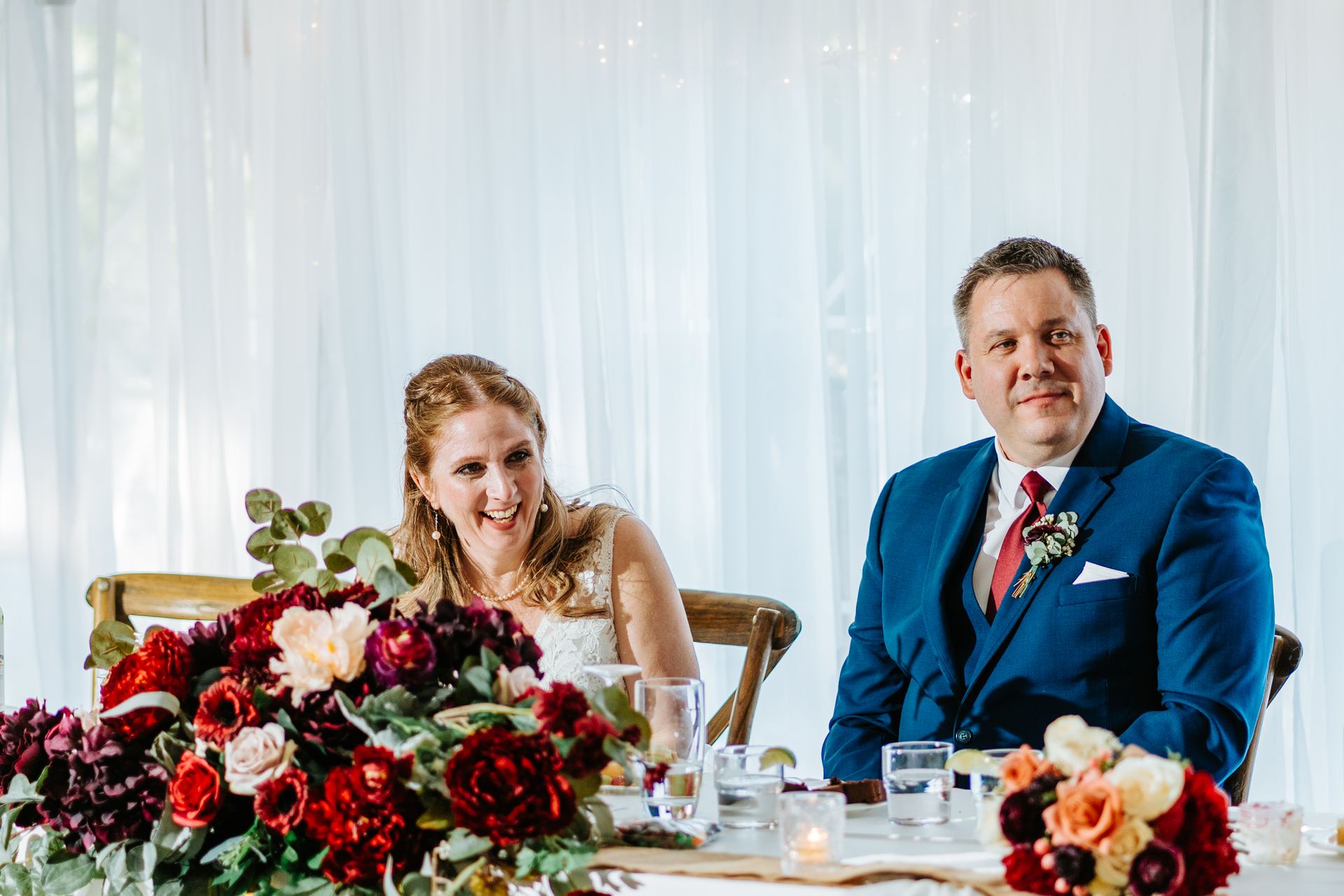 Tara and Carter laughing at the head table during the Pineridge Hollow reception, Pine Ridge, Winnipeg