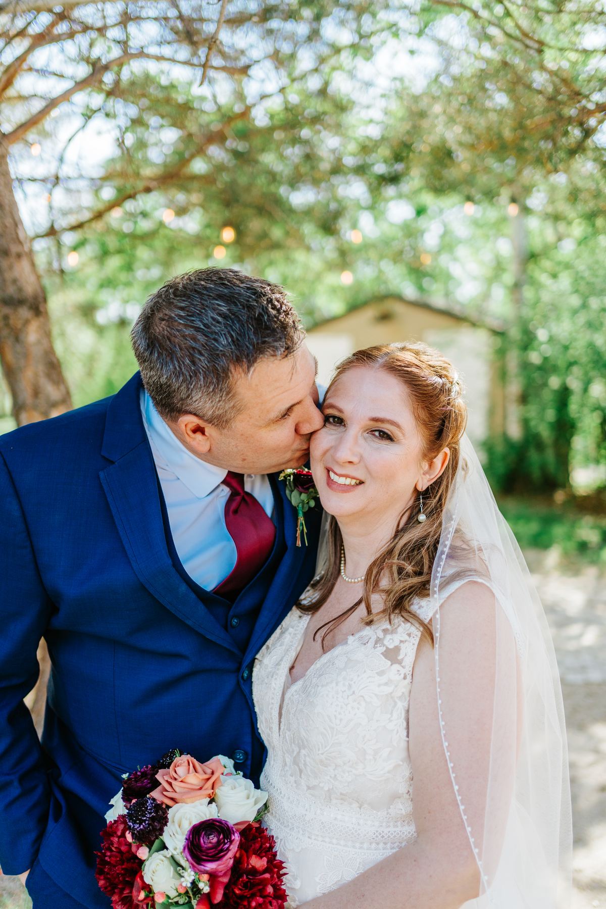 Tara and Carter couple portrait — white ball gown and navy suit in the perennial garden at Pineridge Hollow, Winnipeg wedding photographer