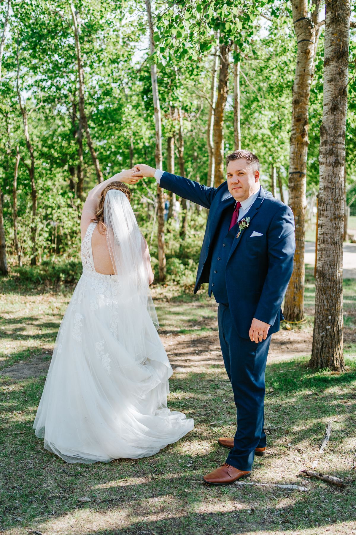 Tara and Carter laughing during couple portraits in the perennial garden at Pineridge Hollow, Winnipeg — Ngo Photography