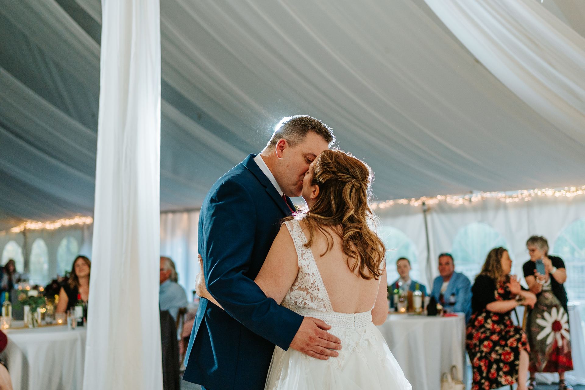 Tara and Carter first dance in the canvas pavilion with string lights at Pineridge Hollow, Pine Ridge, Manitoba