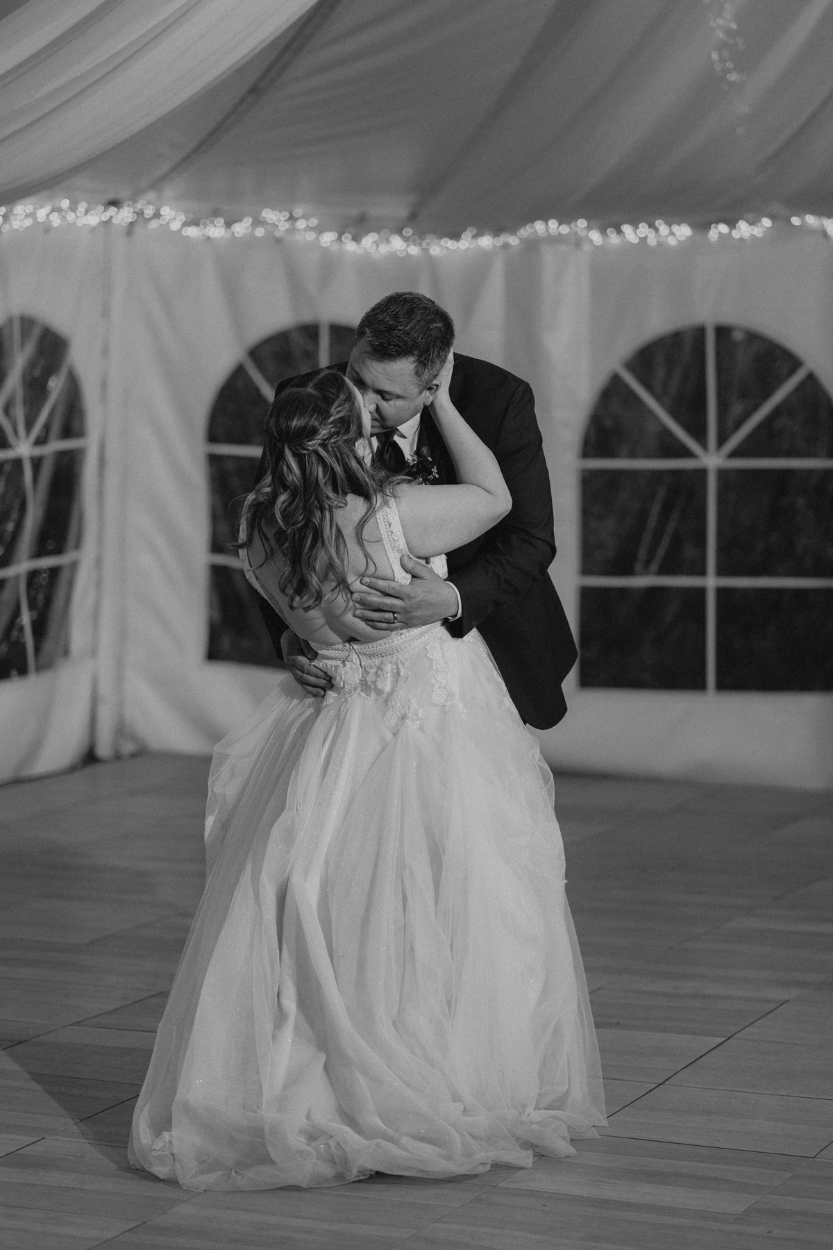 Tara and Carter first dance wide shot in the white canvas pavilion at Pineridge Hollow, Pine Ridge, Manitoba — Ngo Photography