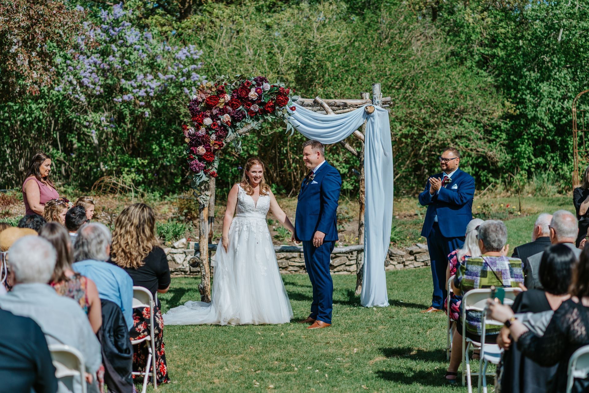 Tara and Carter first kiss as a married couple in the perennial garden at Pineridge Hollow, Pine Ridge, Manitoba