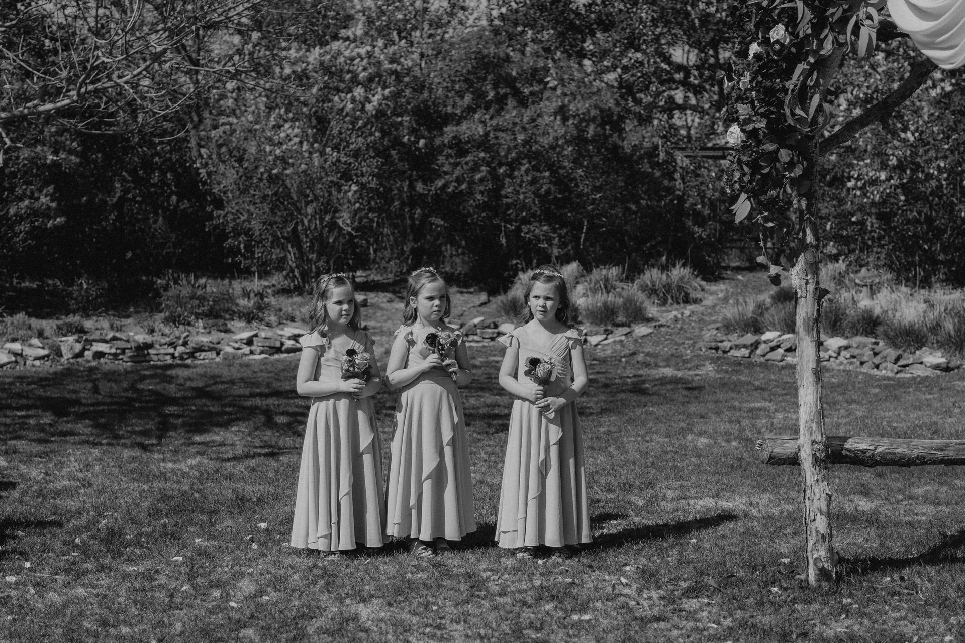 Flower girls candid moment during the ceremony at Pineridge Hollow garden wedding, Manitoba