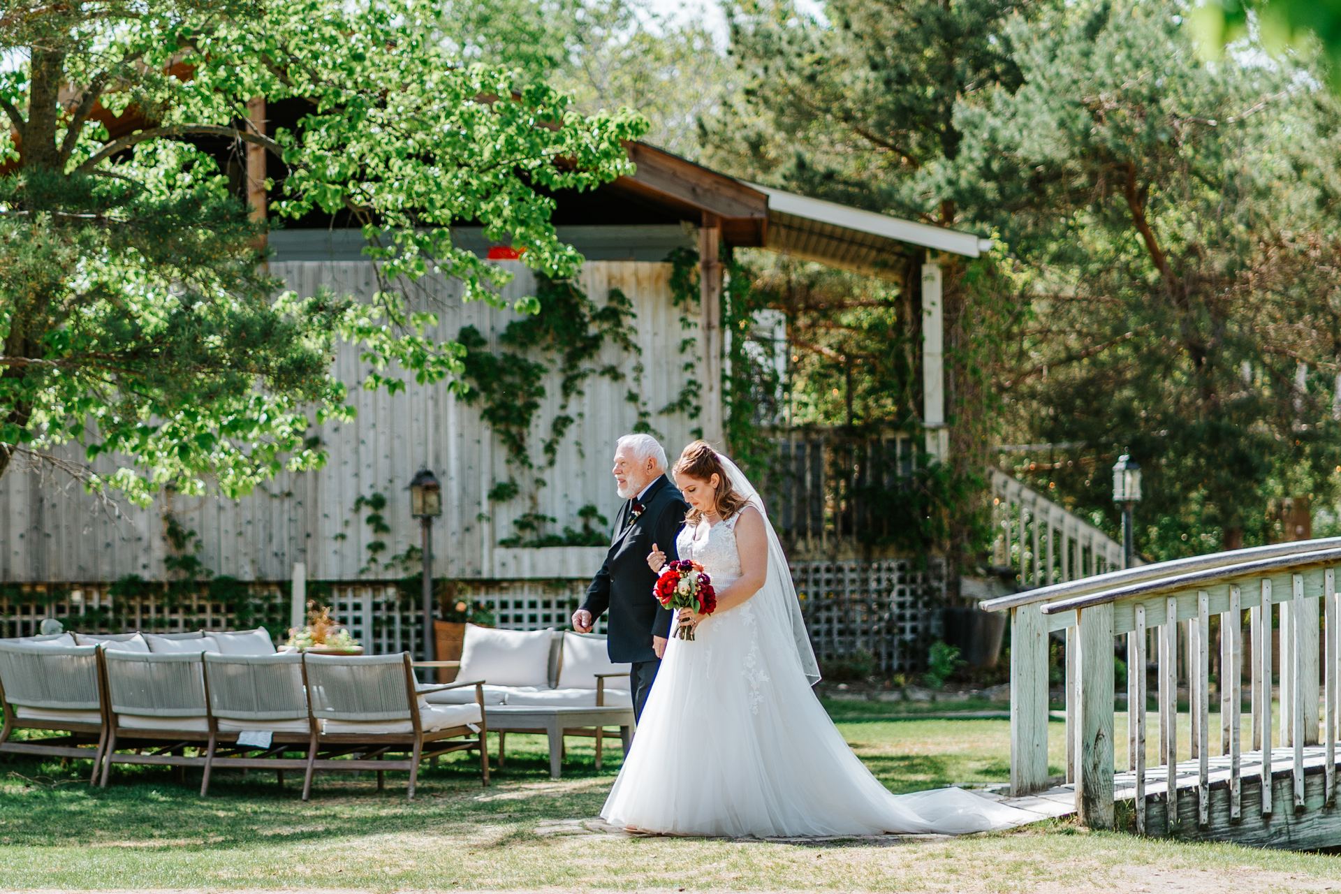 Groom Carter waiting at the altar in the perennial garden ceremony at Pineridge Hollow, Pine Ridge, Manitoba