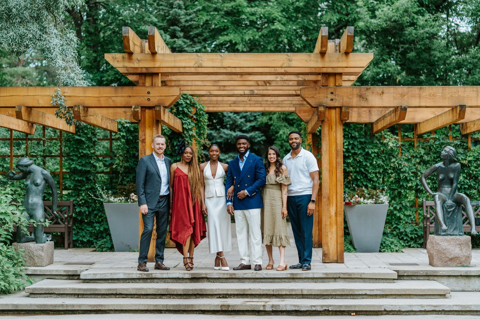 Tobi and Emeka together at Leo Mol Sculpture Garden after their ceremony — candid celebration, Assiniboine Park, Winnipeg