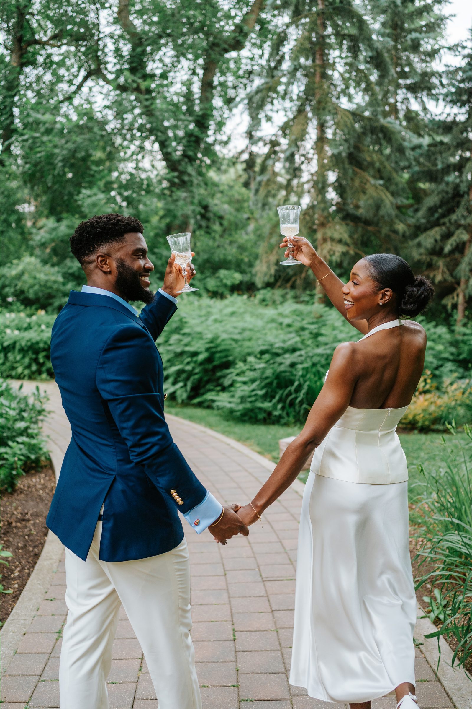 Emeka and Tobi together after signing the marriage licence at Leo Mol Sculpture Garden — smiling, Assiniboine Park, Winnipeg