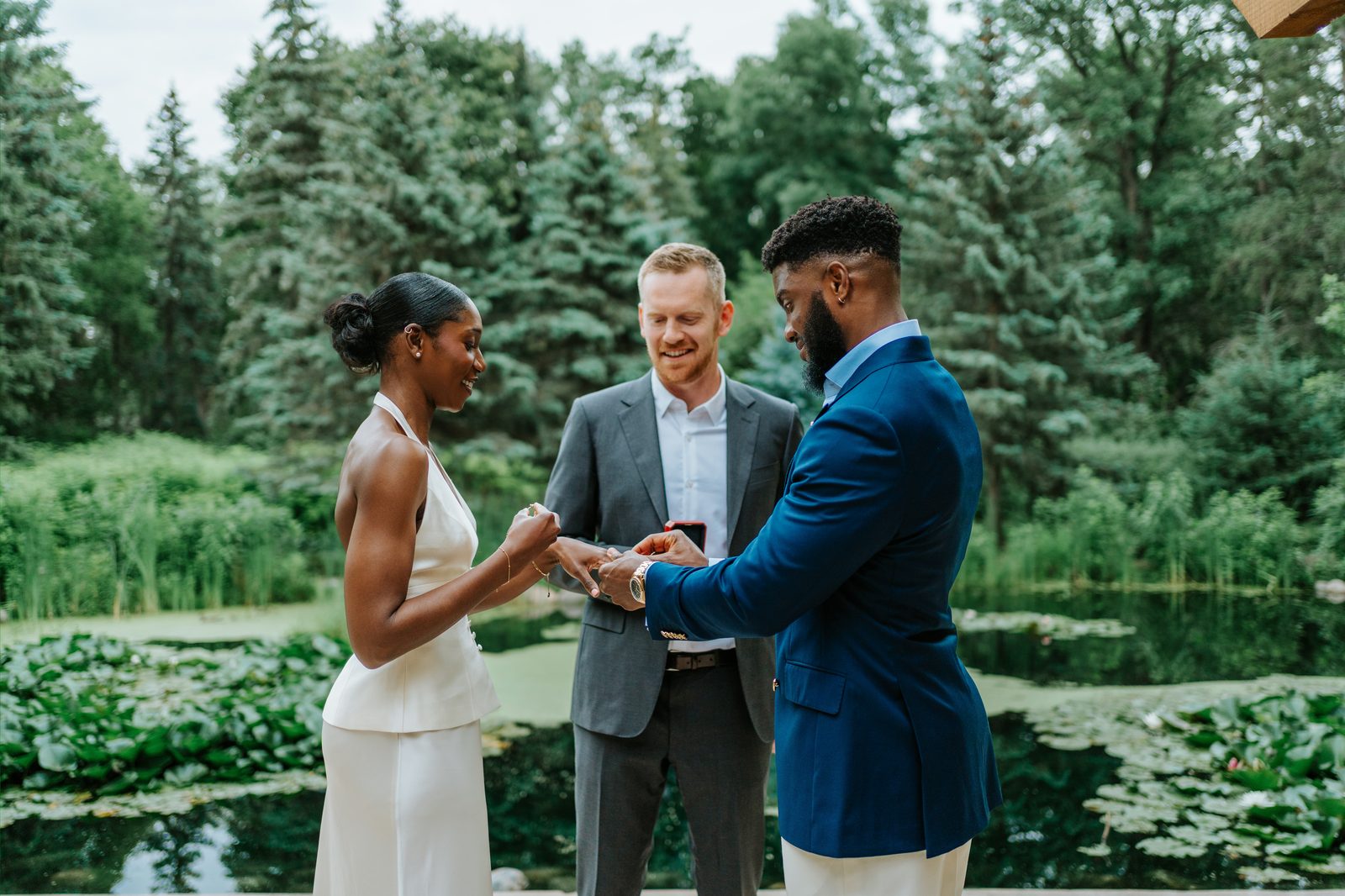 Emeka and Tobi in a tender moment during the ceremony at Leo Mol Sculpture Garden — intimate micro-wedding photography in Assiniboine Park, Winnipeg