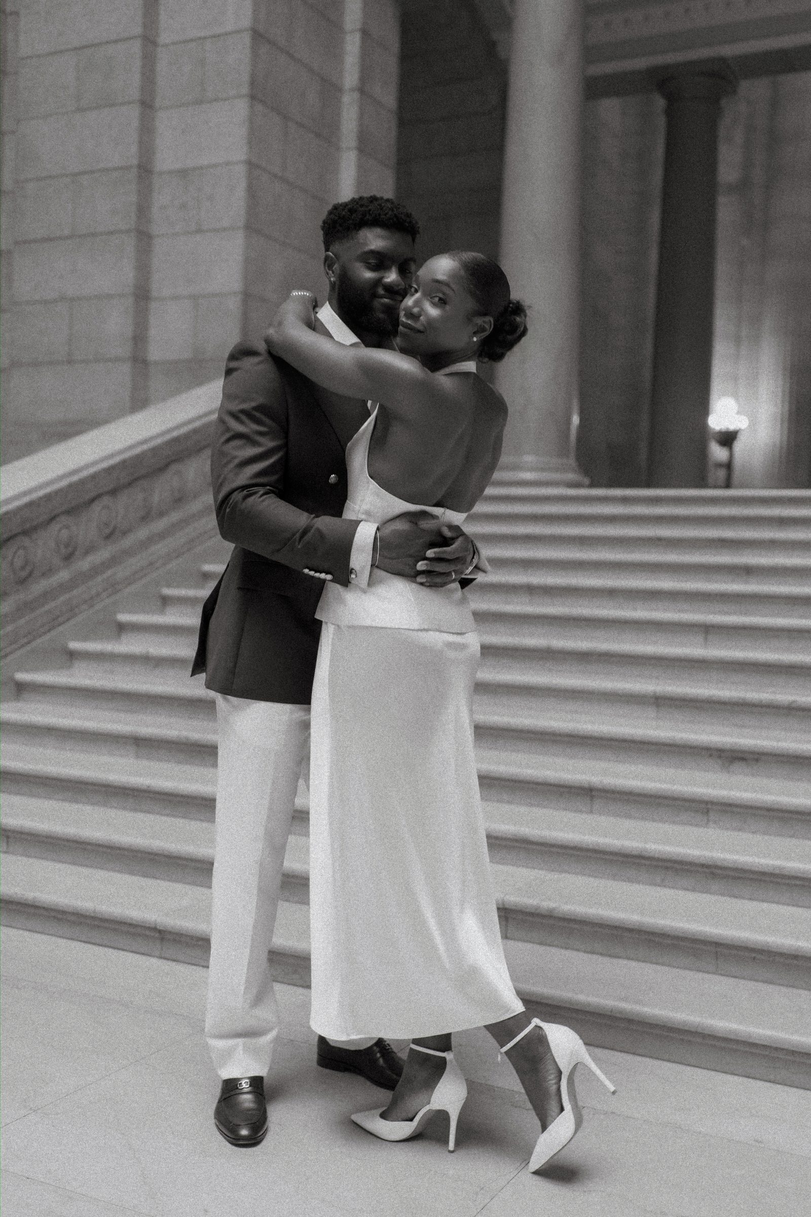 Detail of the Manitoba Legislative Building marble steps and Tobi's white satin midi skirt and ankle-strap stilettos — Winnipeg wedding photography by Ngo Photography