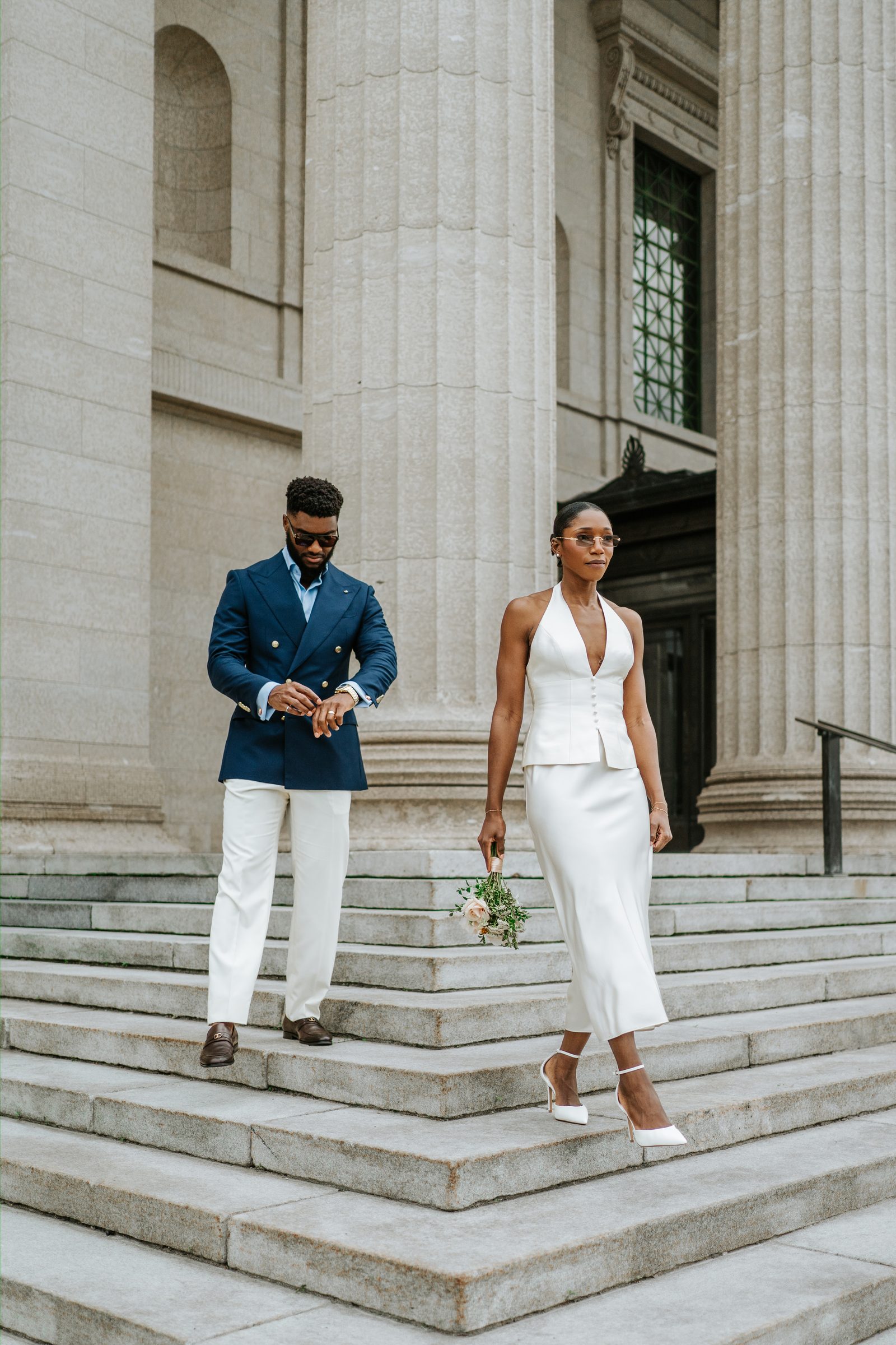 Tobi and a family member or guest together on the exterior steps of the Manitoba Legislative Building — Winnipeg wedding photography