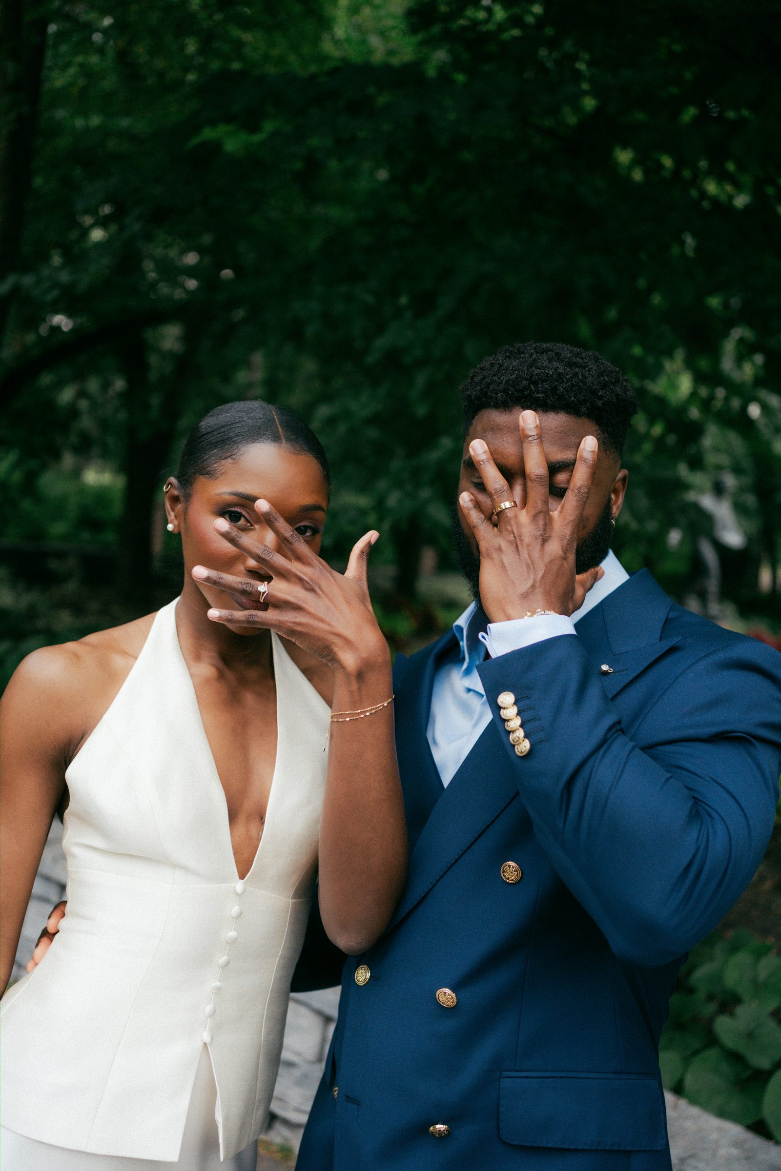 Film-style portrait of Tobi and Emeka together in the garden at Leo Mol Sculpture Garden — Assiniboine Park, Winnipeg