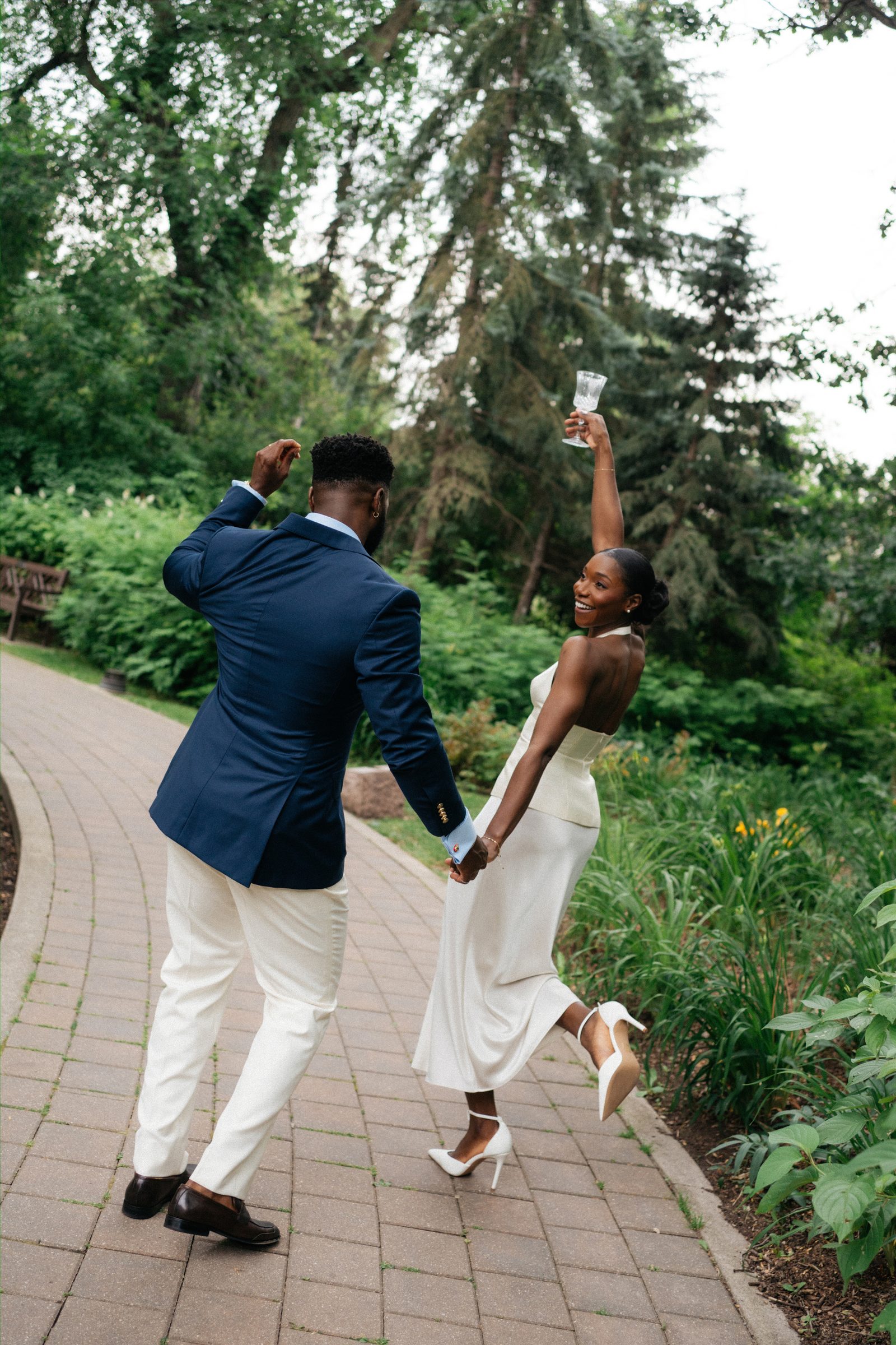 Film-style close portrait of Tobi and Emeka together — Leo Mol Sculpture Garden, Assiniboine Park, Winnipeg