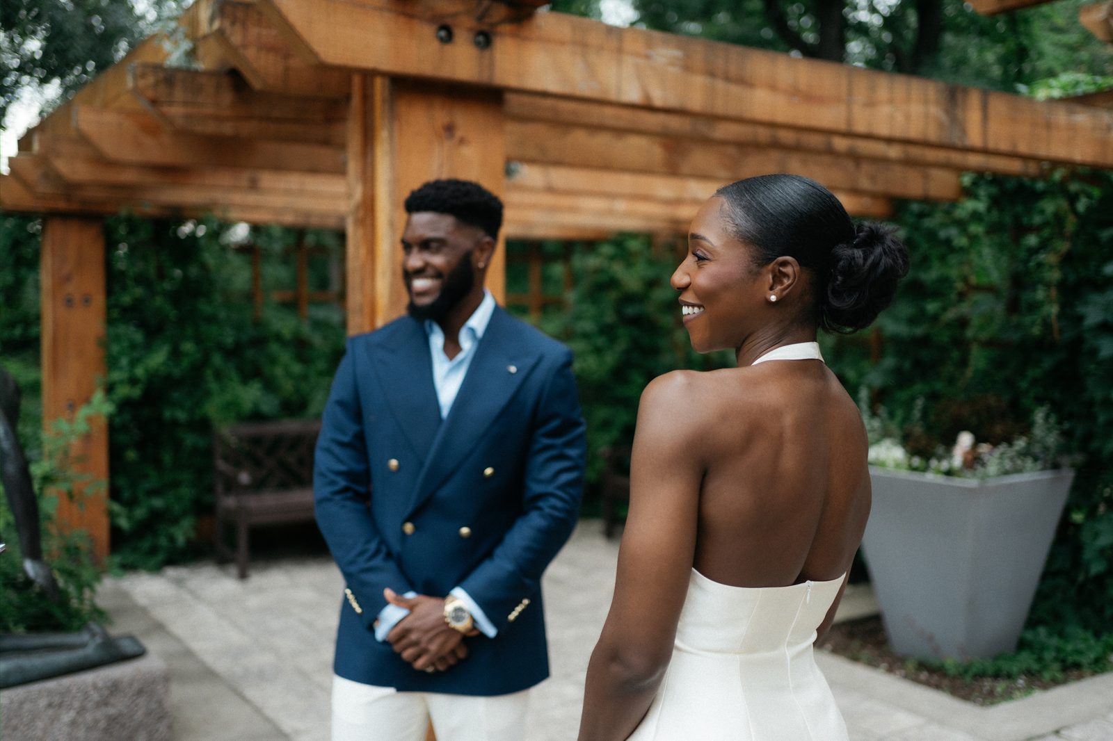 Film-style portrait — Tobi and Emeka together at Leo Mol Sculpture Garden in Assiniboine Park, Winnipeg