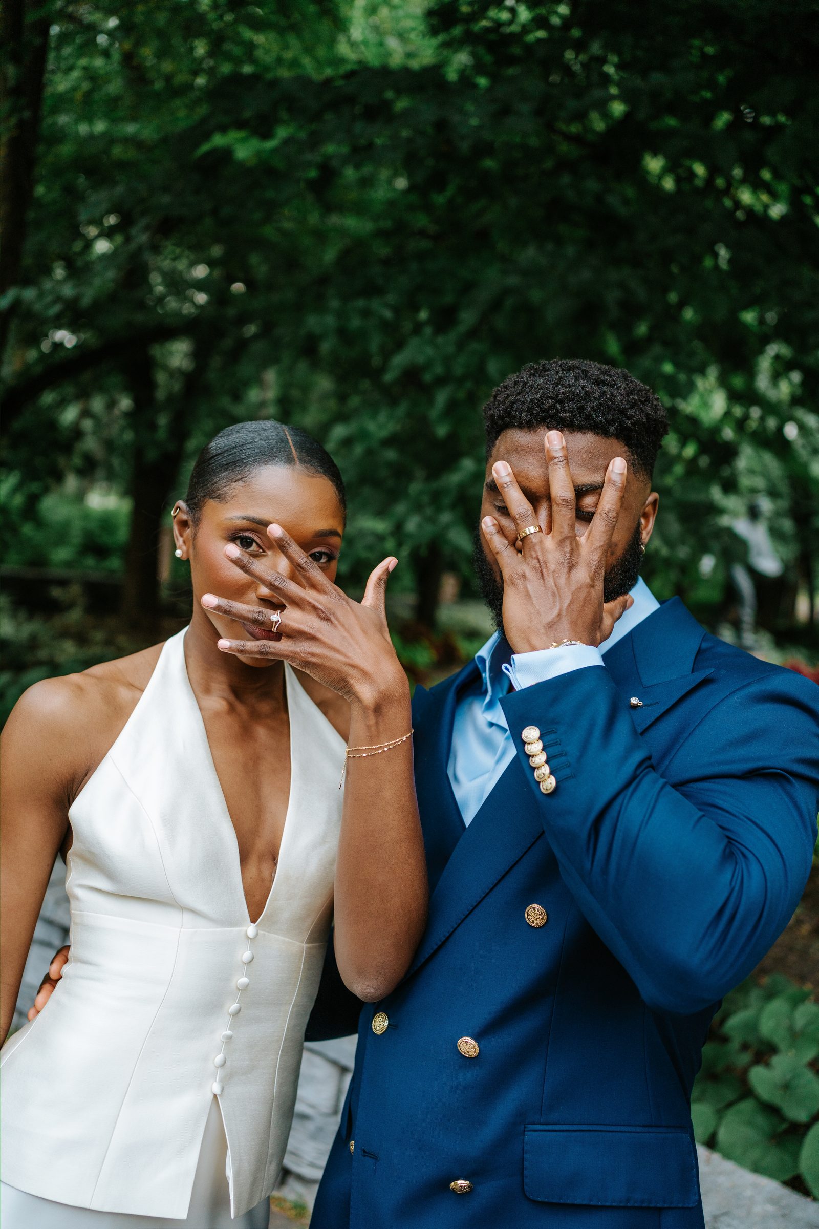 Emeka and Tobi together in the garden at Leo Mol Sculpture Garden, Assiniboine Park — Winnipeg wedding photography by Ngo Photography